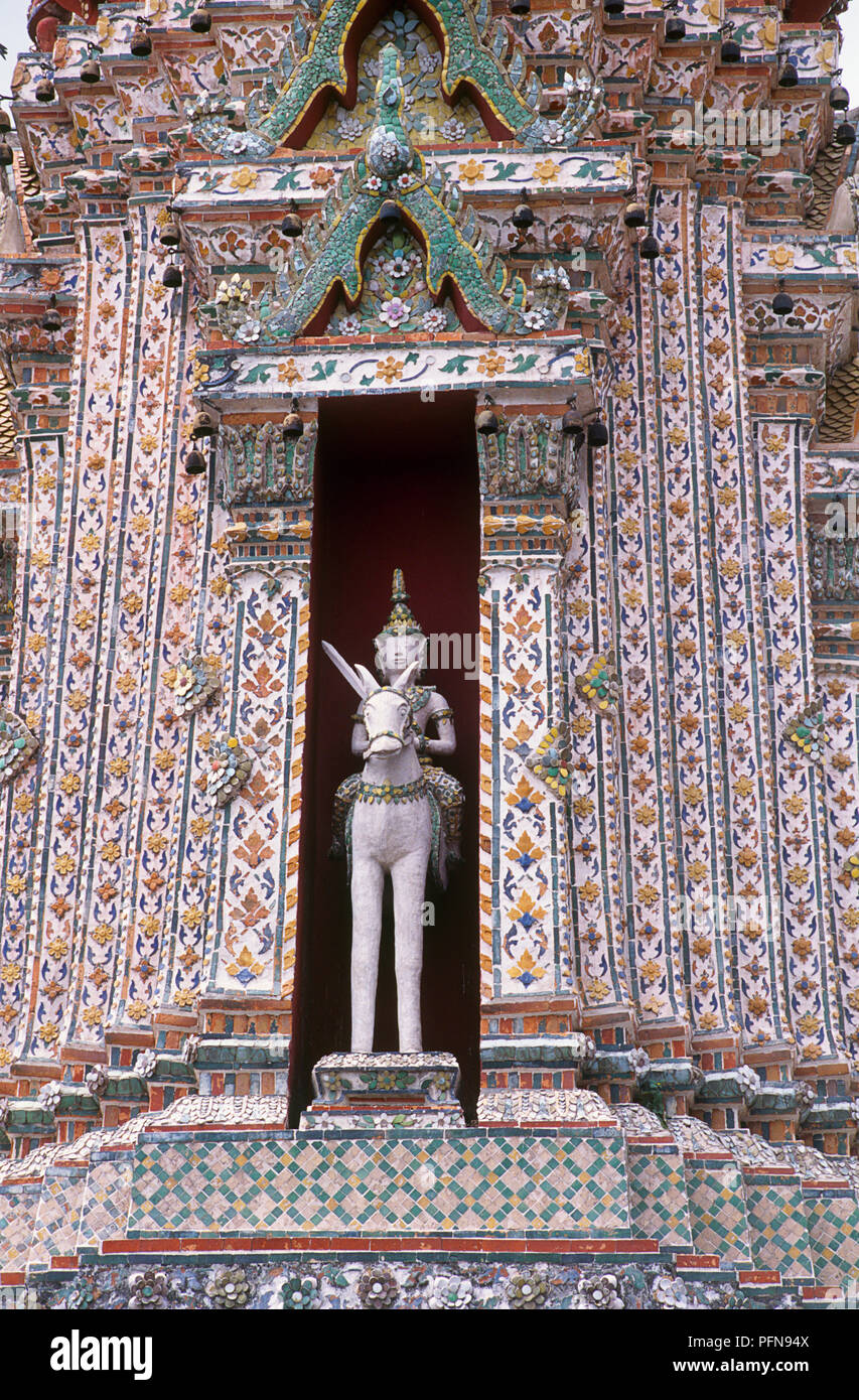 Thailand, Bangkok, Wat Arun (Temple of The Dawn), niche statue of Nayu on horseback decorating central prang Stock Photo