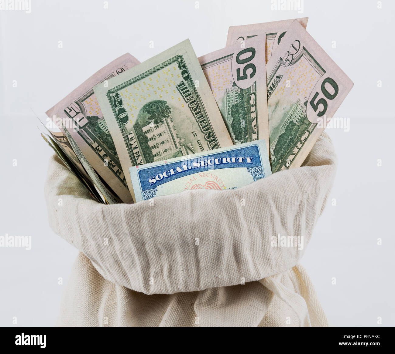 Many US dollar bills or notes in money bag with social security card Stock Photo