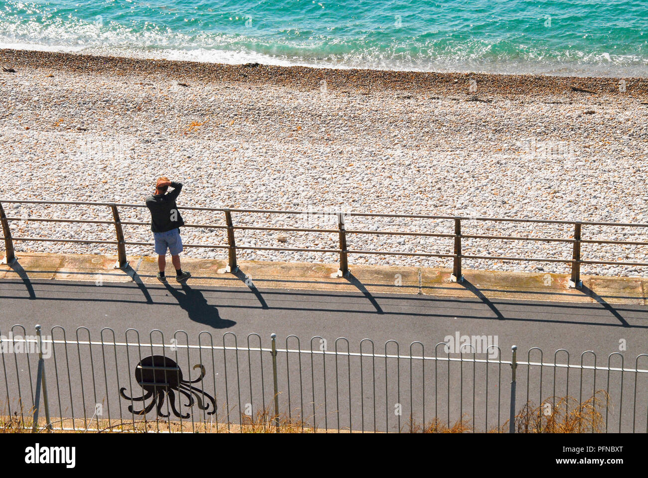 Chesil Beach. 21st August 2018. Two males enjoy swimming off Chesil Beach,  Portland, in Dorset, the