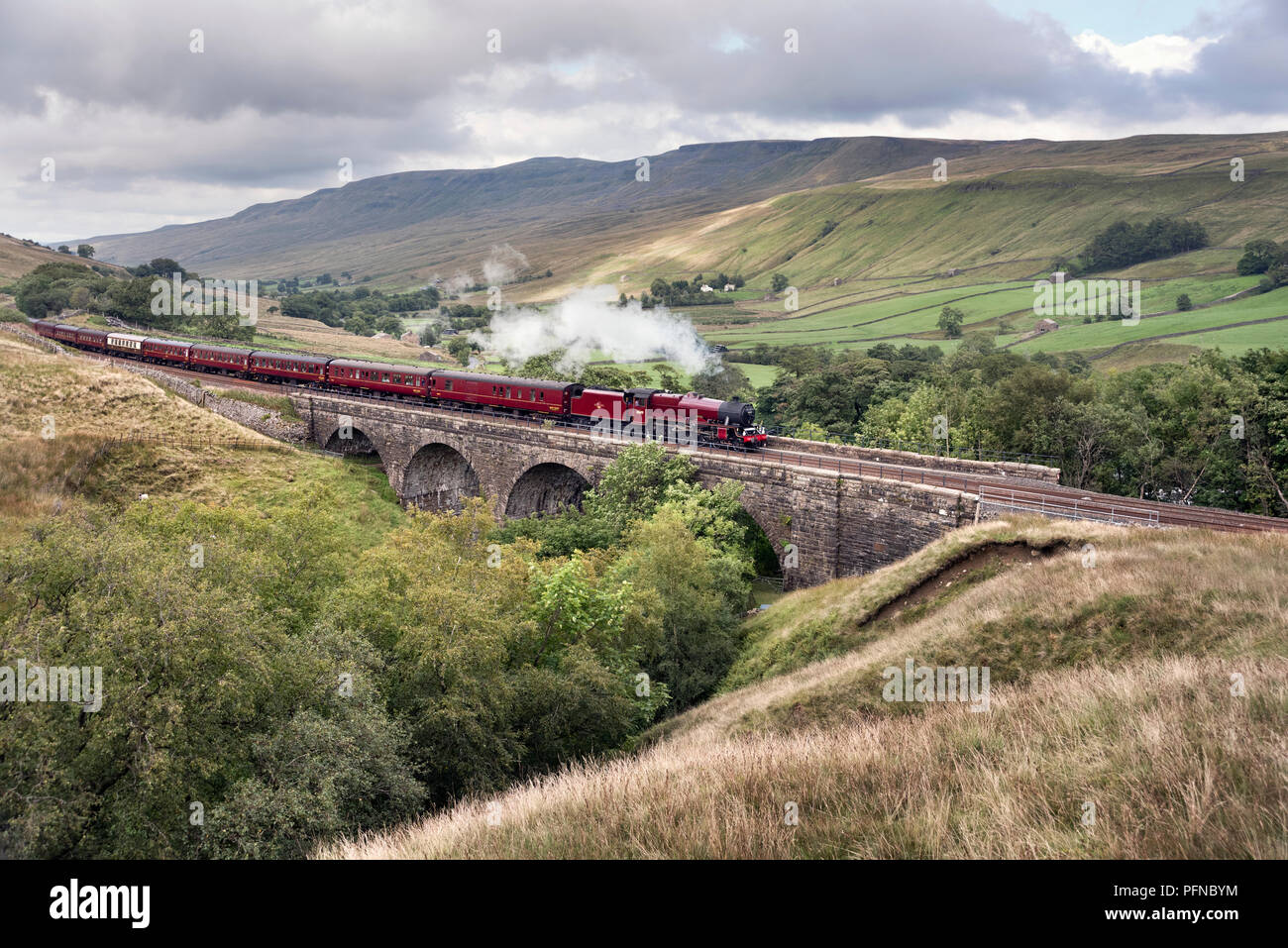 Yorkshire Dales National Park, UK. 21st Aug, 2018. Steam locomotive 'Galatea' hauls 'The Fellsman' special, an excursion from Lancaster to Carlisle and return, via the famous Settle to Carlisle railway line. Seen here at Ais Gill Viaduct  in the Yorkshire Dales National Park, near Kirkby Stephen, southbound on the return journey. Credit: John Bentley/Alamy Live News Stock Photo