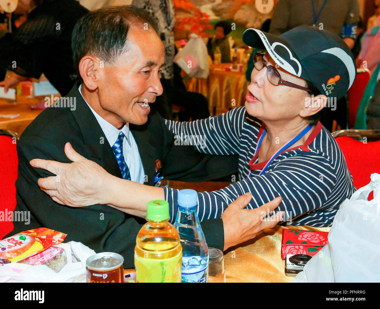Inter-Korean Family Reunion, Aug 21, 2018 : South Korean Kim Hye-Ja (R, 75) hugs her North Korean younger brother Kim Eun-Ha during an inter-Korean family reunion at Kumgangsan hotel in Mt. Kumgang resort, North Korea in this picture taken by Joint Press Corps at Mt. Kumgang and handouted by the South Korean Ministry of Unification. Eighty-nine elderly South Koreans crossed the Demilitarized Zone separating the two Koreas on August 20 to meet their North Korean relatives for the first time since they were mostly separated by the 1950-53 Korean War, during a three-day inter-Korean family reunio Stock Photo