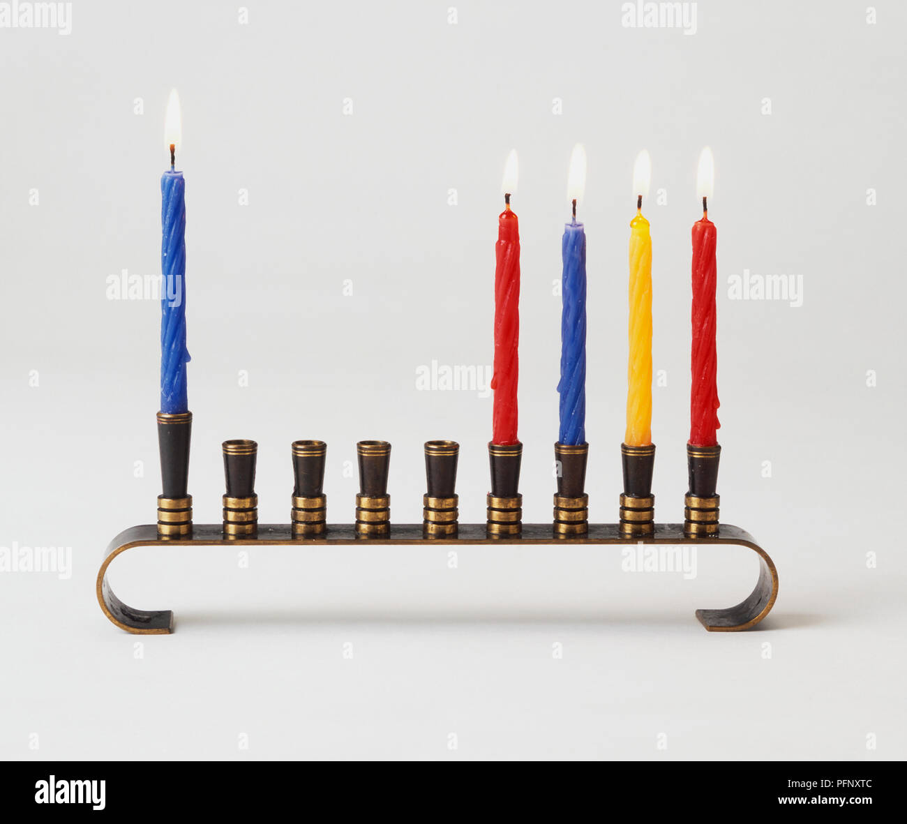 Five lit Hanukkah candles on a menorah Stock Photo Alamy