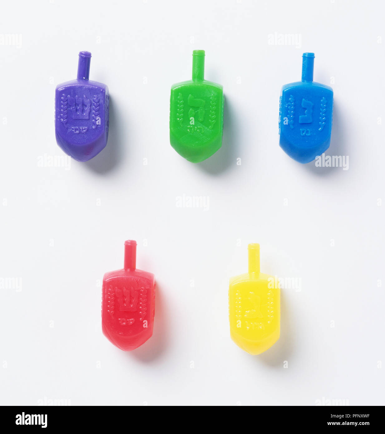 Five different coloured spinning tops (Dreidels Stock Photo Alamy