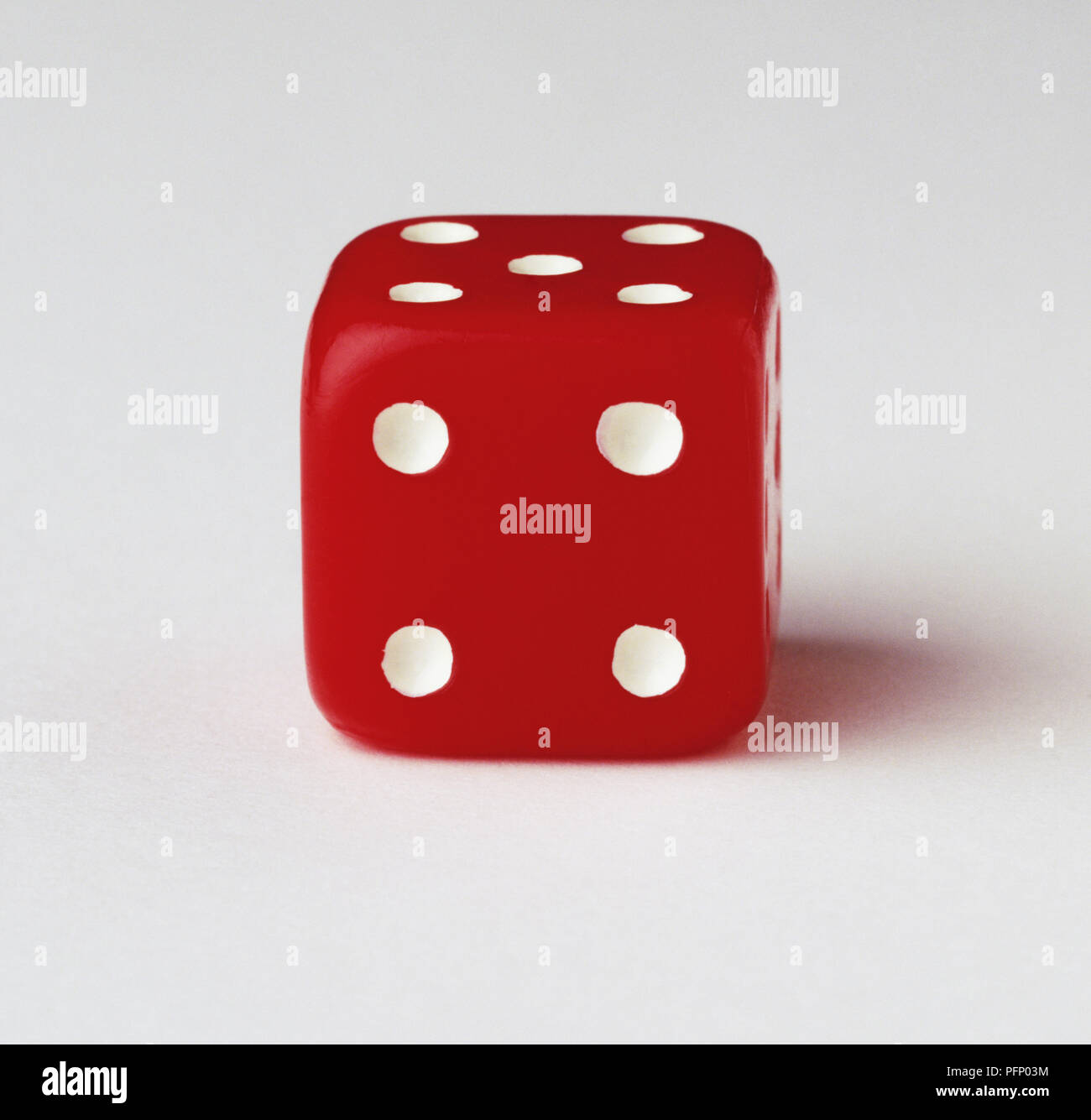 Red dice with four-dot side facing the camera, close up Stock Photo