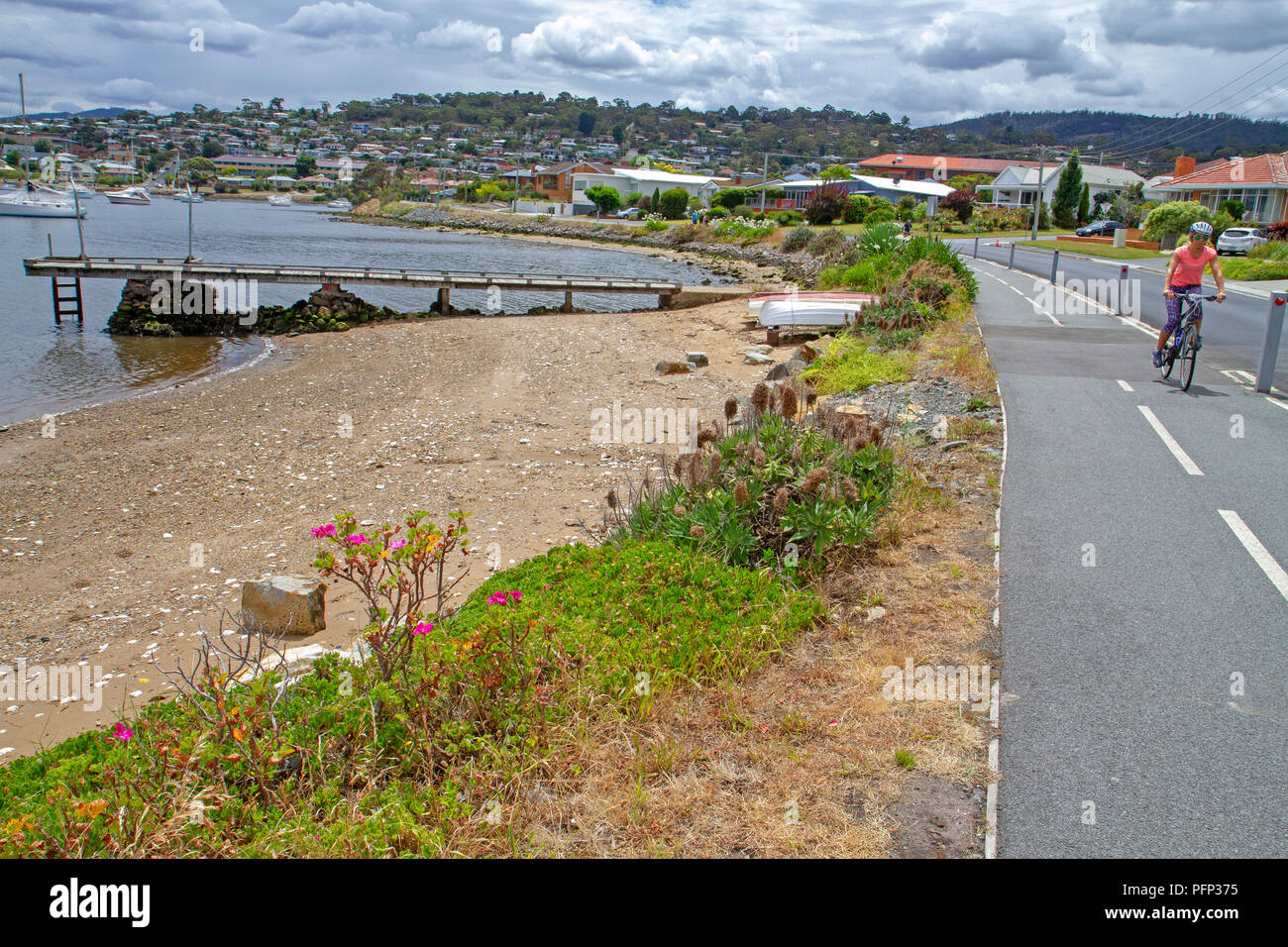 Cyclist on the Clarence Foreshore Trail in Hobart Stock Photo