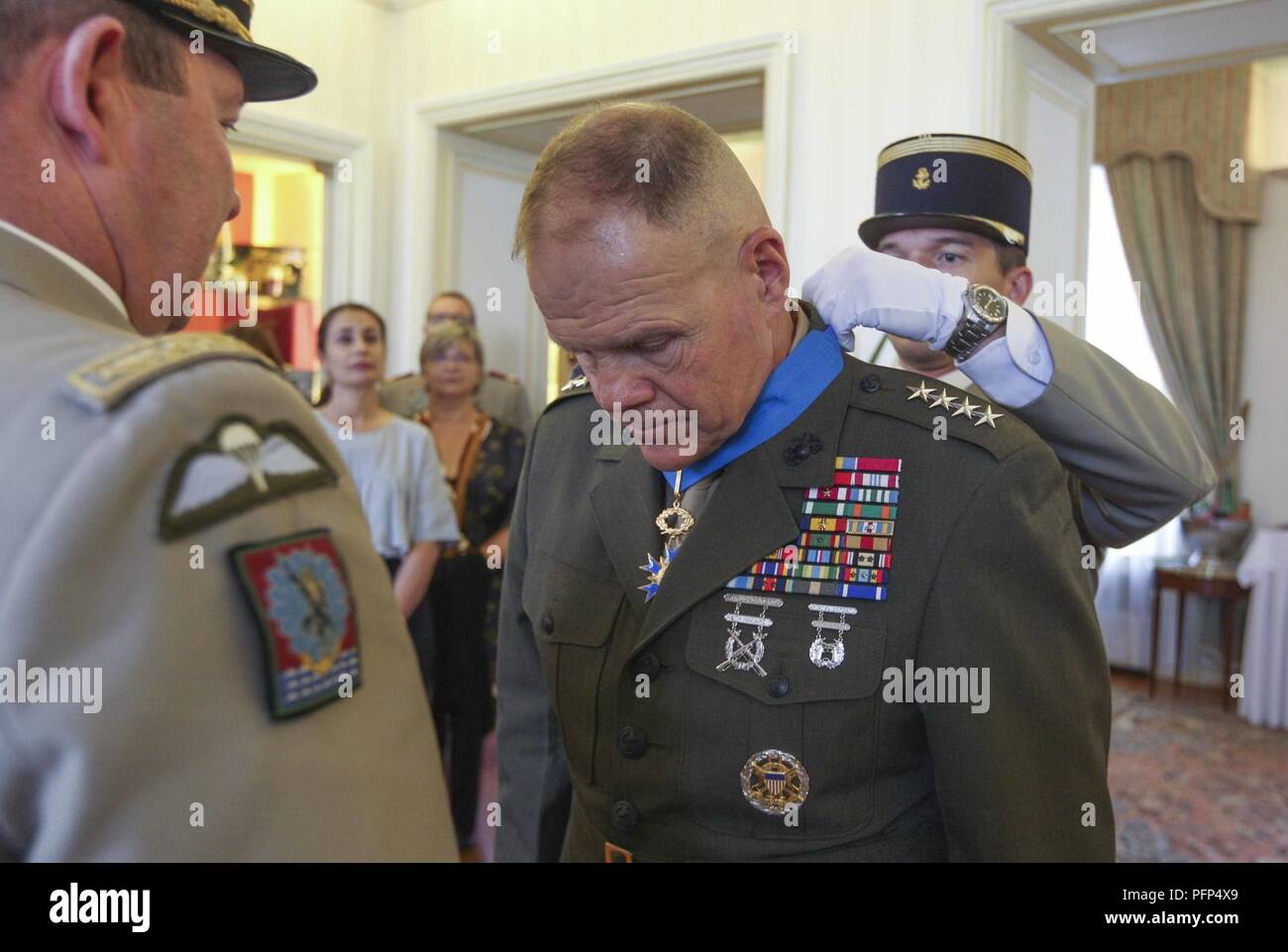 Commandant of the Marine Corps Gen. Robert B. Neller is presented an award  at Les Invalides, Paris, France, May 24, 2018. Gen. Neller received the  French National Order of Merit Award from