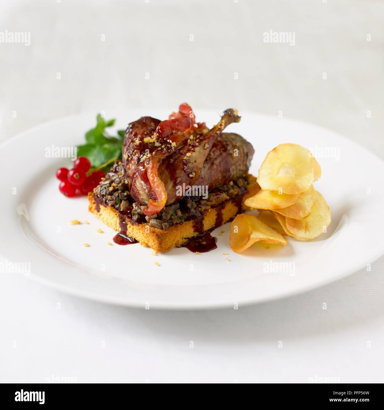 Grouse on toast served with redcurrant sauce Stock Photo