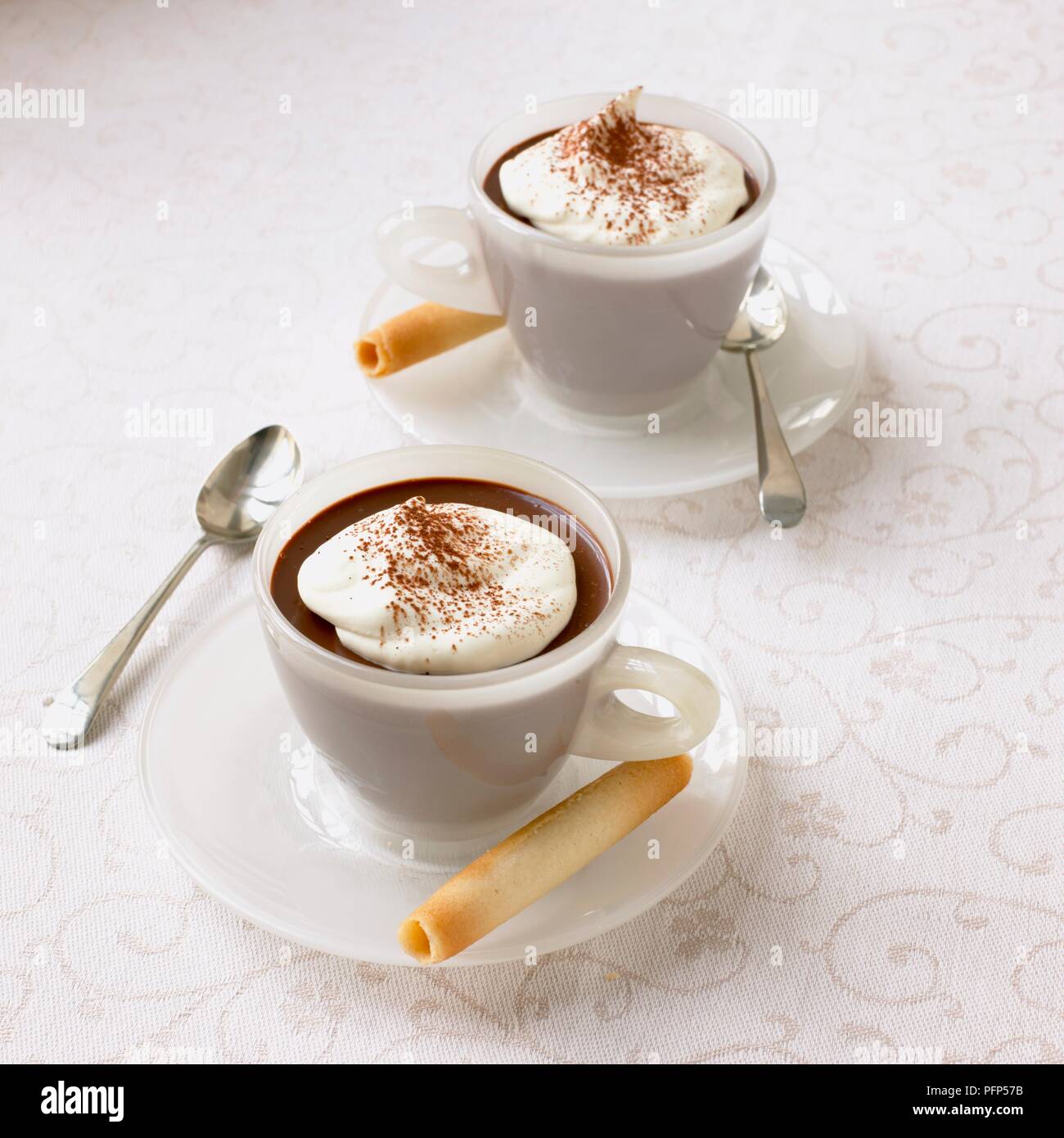 Chocolate cappuccinos on tablecloth Stock Photo