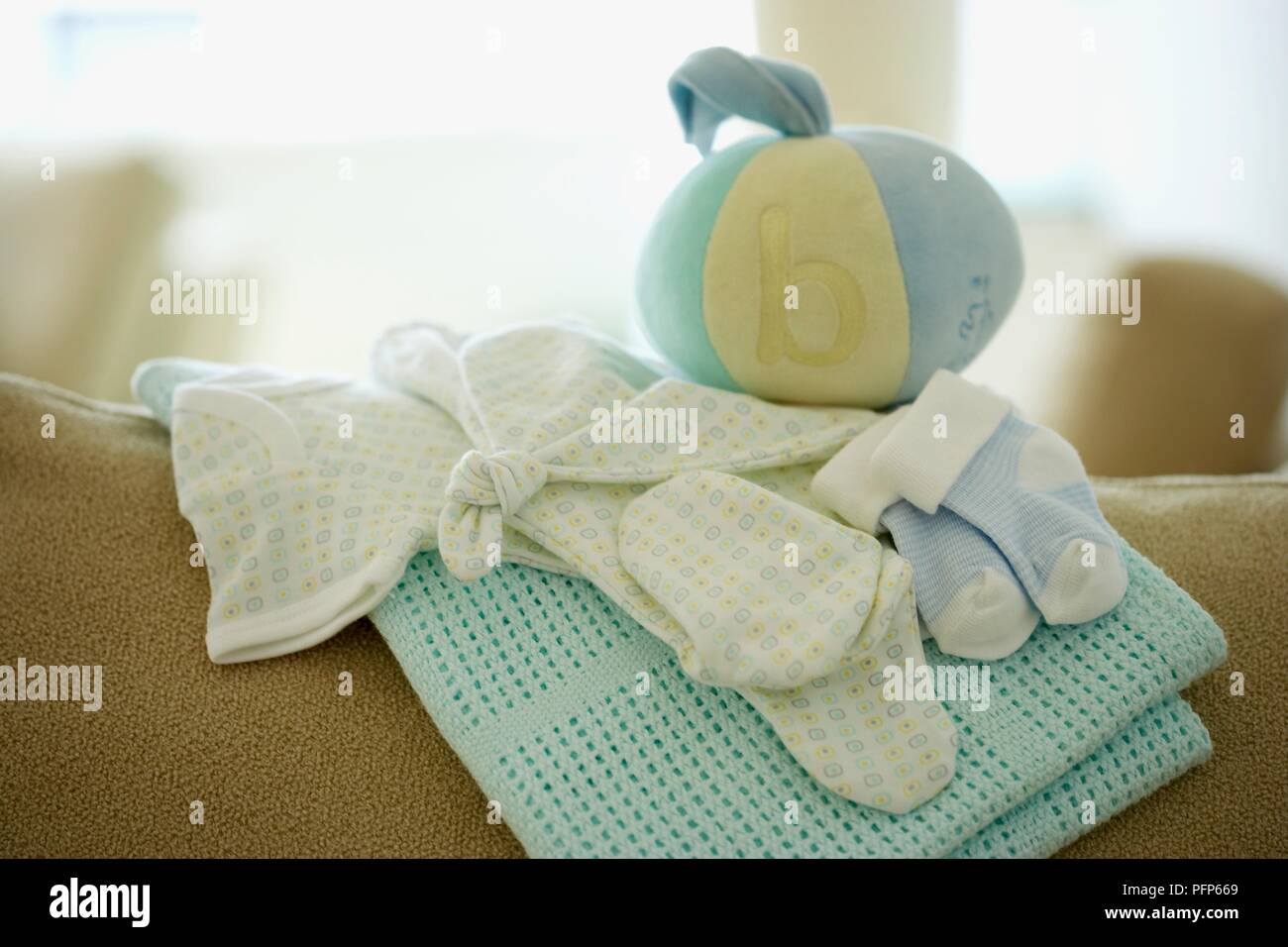 Baby blanket, clothing and ball Stock Photo