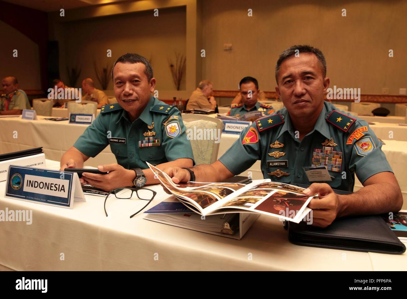 Indonesian Marine Corps Brig. Gen. Nur Alamsyah, left, 2nd Marine Force Commander, Indonesian Marine Corps and Indonesian Navy First Adm. Rachmad Jayadi, commander, Sea Battle Task Force, Eastern Fleet Command, look over the Pacific Amphibious Leaders Symposium (PALS) photo book during PALS in Honolulu, Hawaii, on May 24, 2018. PALS brings together senior leaders of allied and partner militaries with significant interest in the security and stability of the Indo-Pacific region to discuss key aspects of maritime/amphibious operations, capability development, crisis response and interoperability Stock Photo