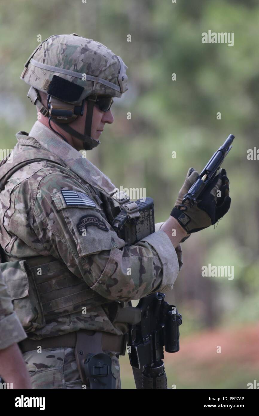 Staff Sgt. Justin Danforth, a Denver, Colorado-native and infantryman assigned to Company A, 1st Battalion, 325th Airborne Infantry Regiment, 2nd Brigade Combat Team, 82nd Airborne Division, loads an M9 Pistol during the last day of the Small Arms Competition as part of All American Week XXIX at Fort Bragg, North Carolina, May 23, 2018.  Paratroopers past and present converged on the center of the military universe to celebrate being members of the “All American” Division and America’s Guard of Honor. Stock Photo