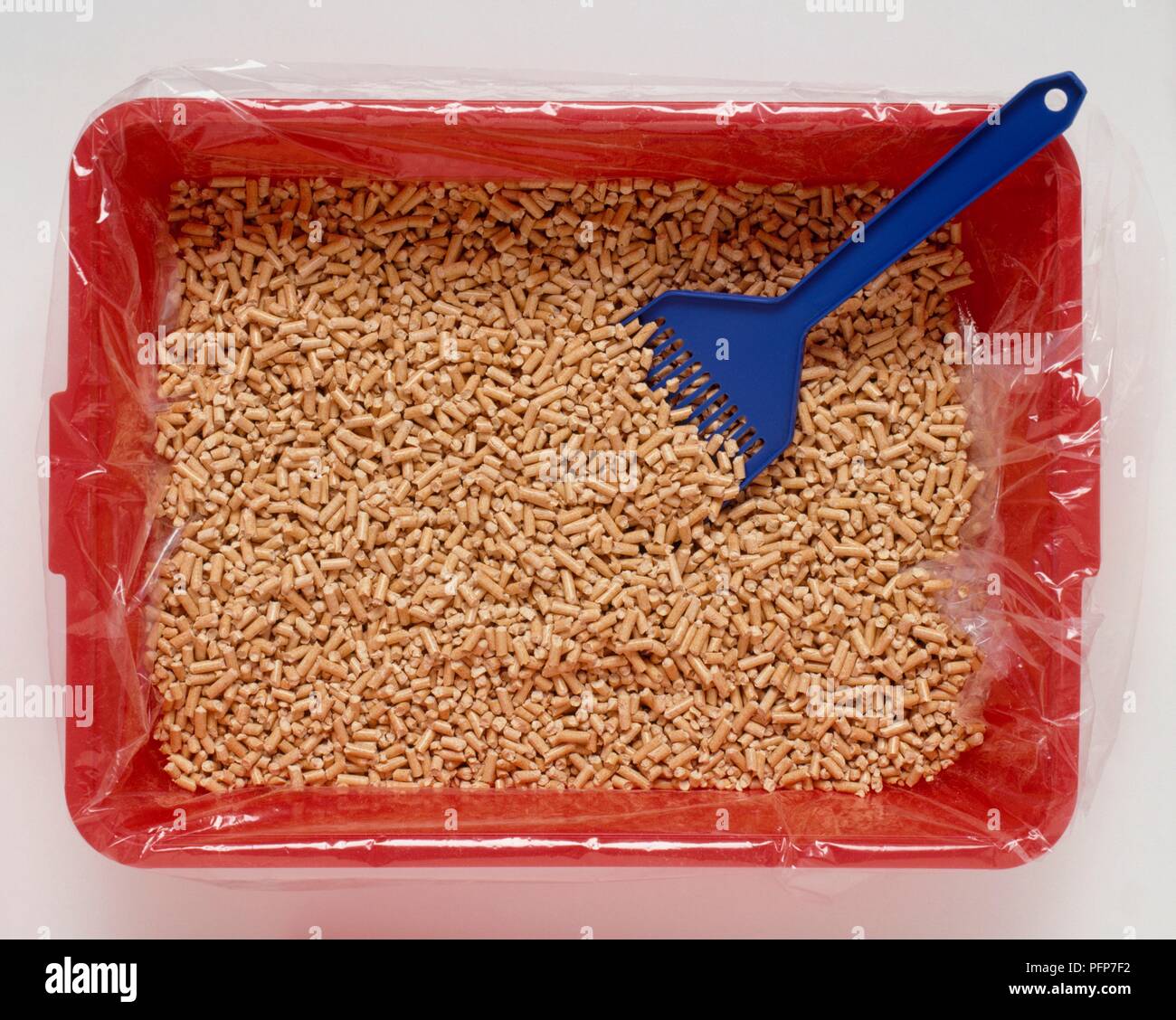 Pellets and scoop in litter tray, overhead view Stock Photo Alamy