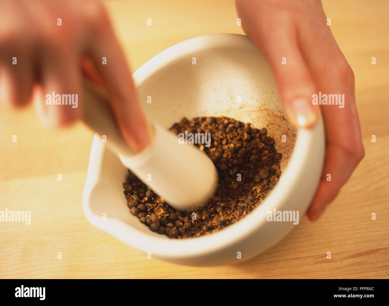 Using pestle and mortar to grind seeds, blurred motion Stock Photo Alamy