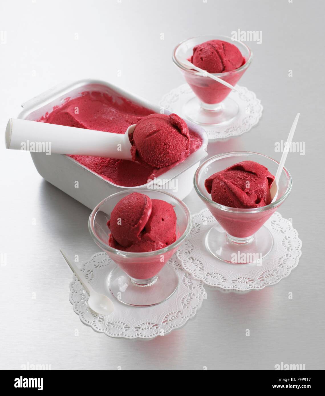 Raspberry sorbet in dish with scoop and served in sorbet glasses on doilies  Stock Photo - Alamy