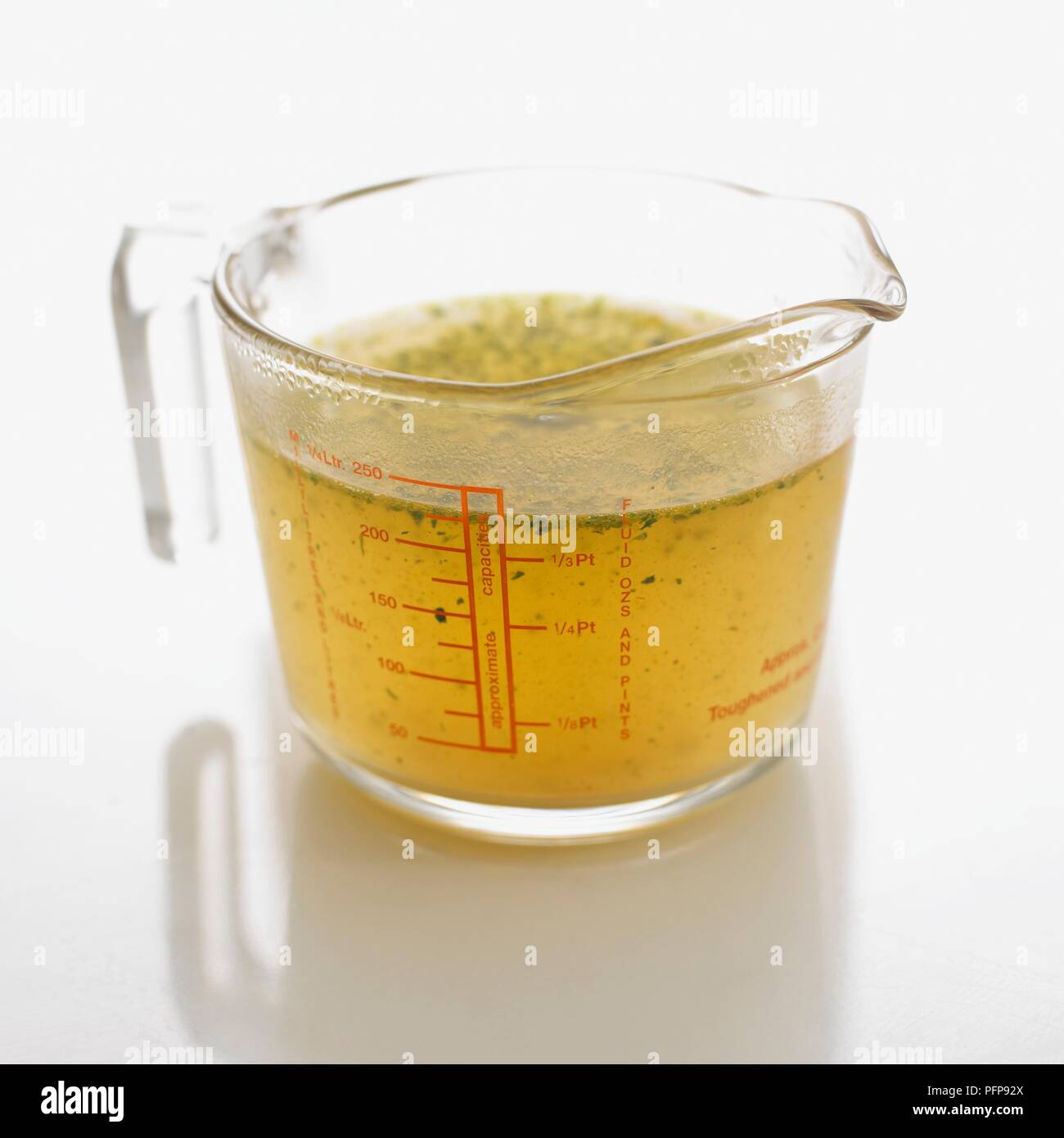 Gravy cube and spoon in measuring jug of hot water