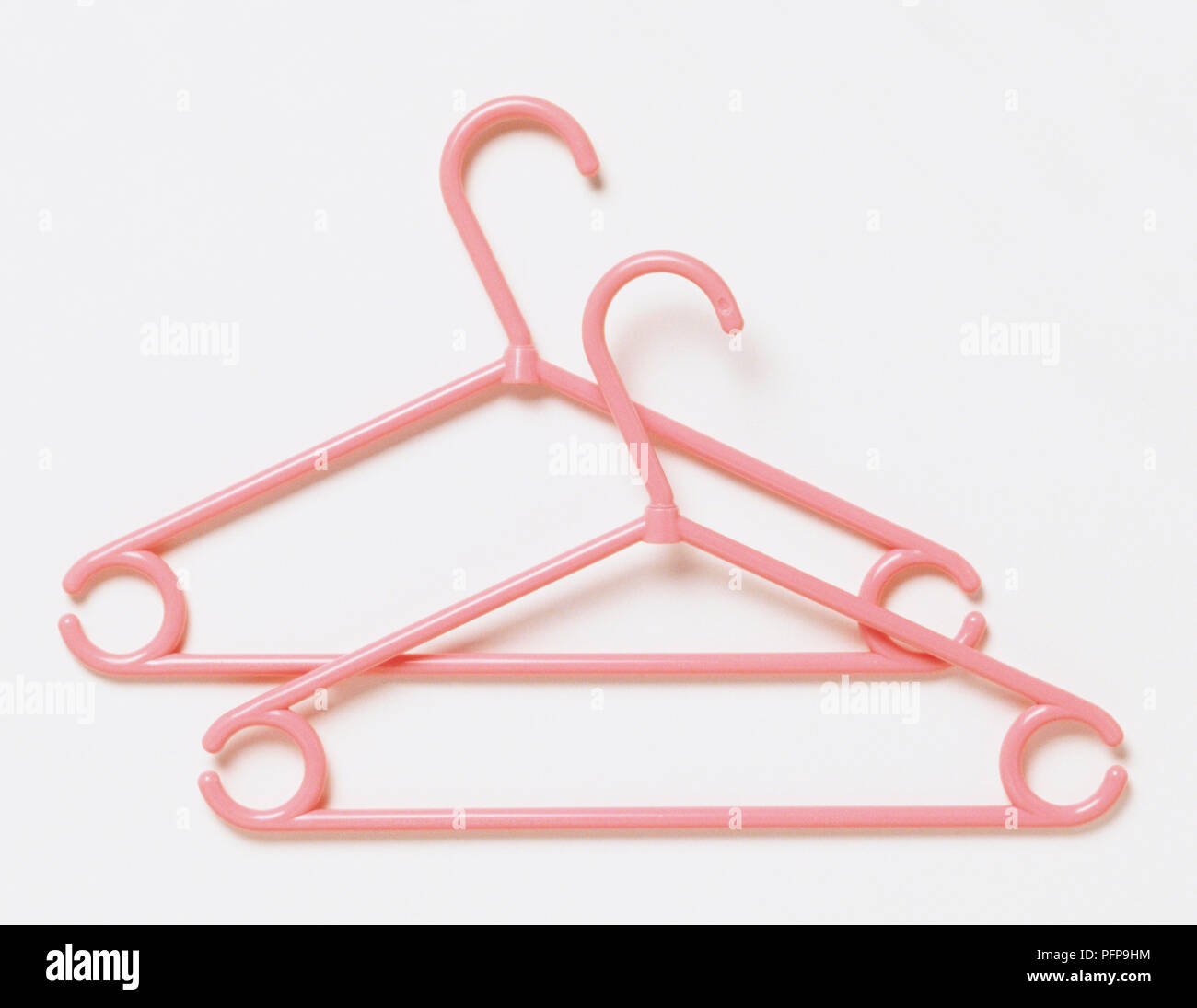 https://c8.alamy.com/comp/PFP9HM/two-pink-plastic-coat-hangers-PFP9HM.jpg