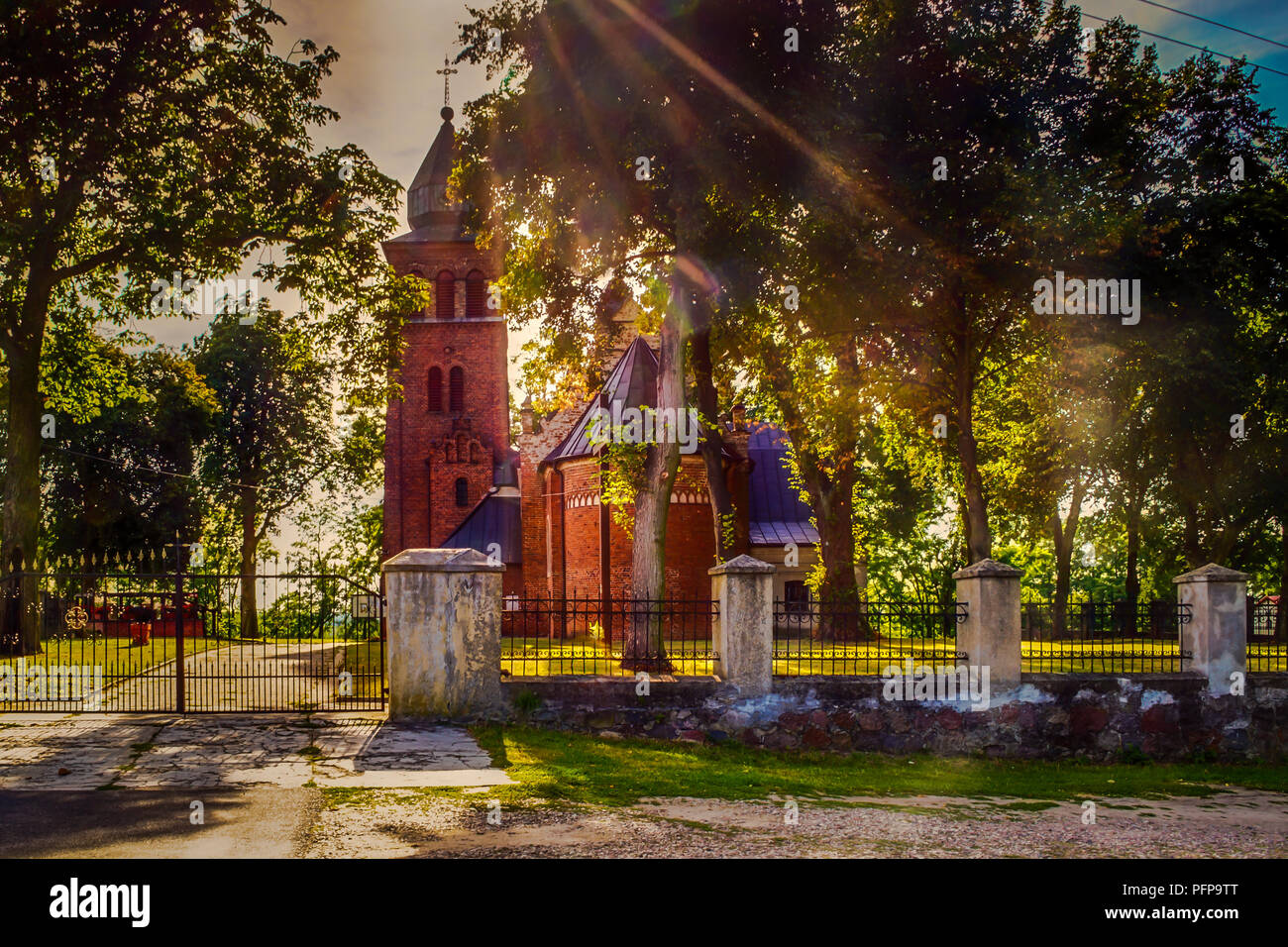Church in the park illuminated by the setting sun Stock Photo - Alamy