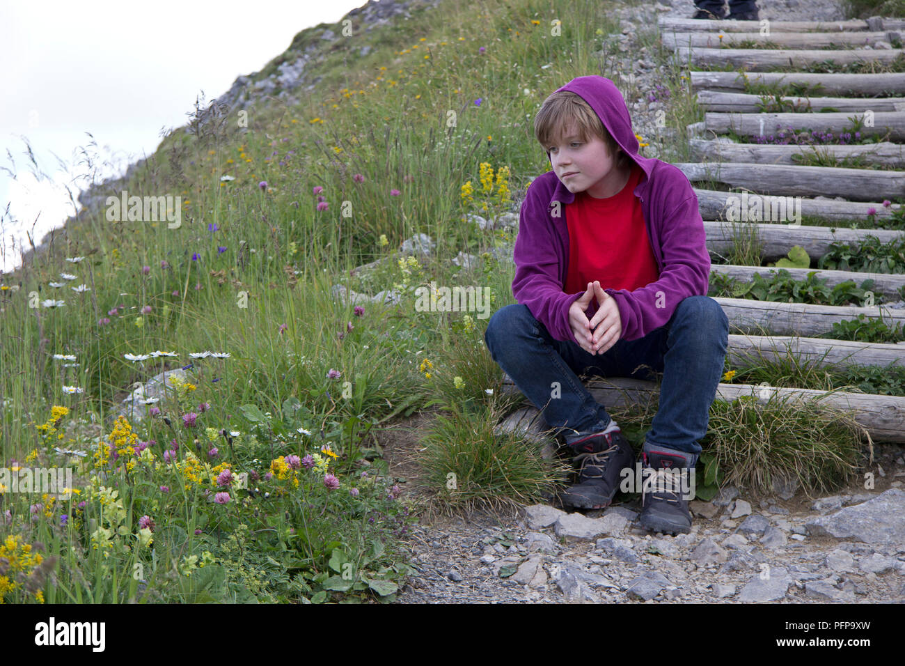 boy having a break from hiking to the summit, Kanzelwand, Riezlern, little Walser valley, Austria Stock Photo