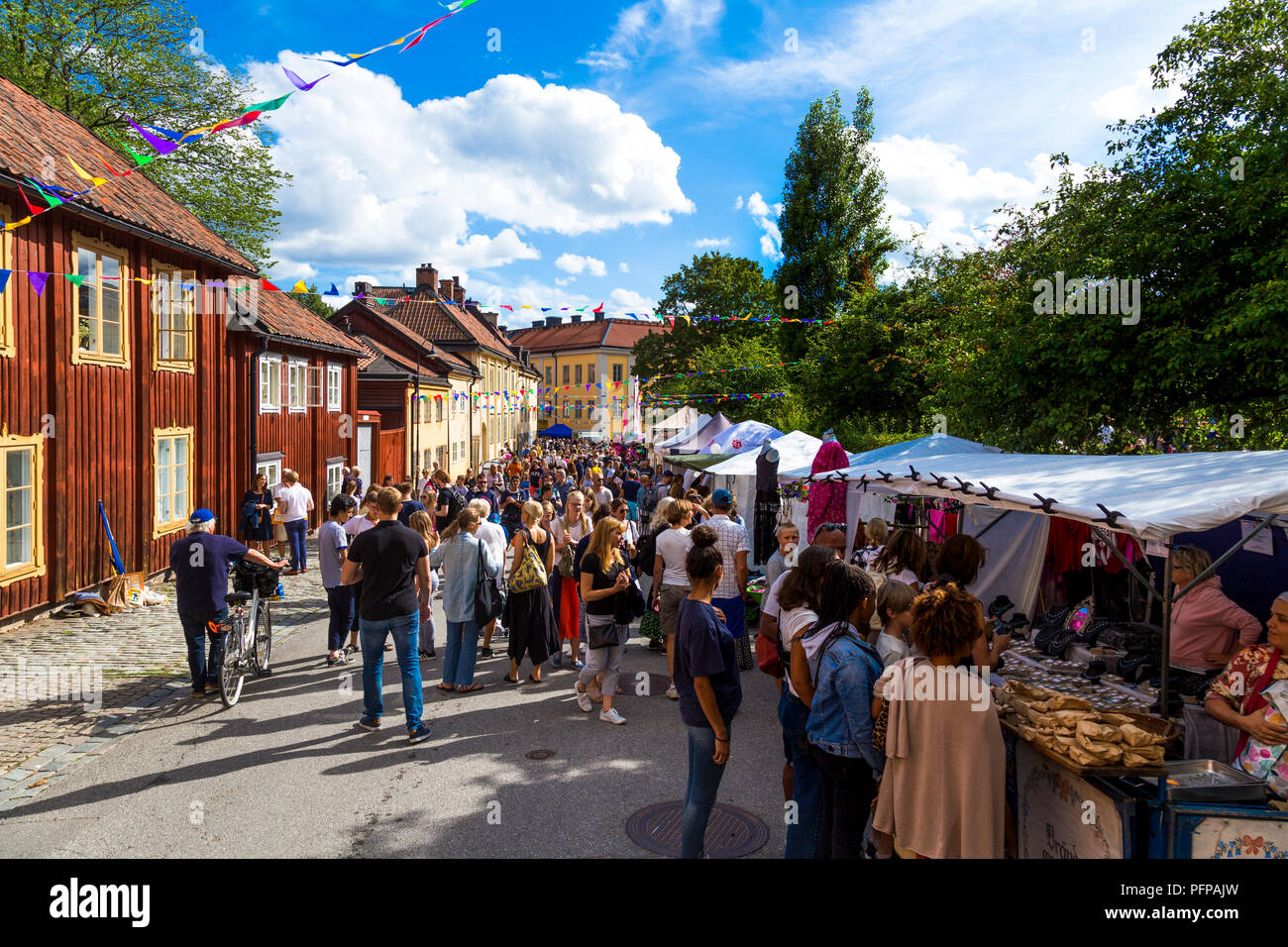 Crowds of people and traditional Swedish houses at street market festival at Nytorget, Sodermalm, Stockholm, Sweden (Nytorgsfesten 18th August 2018) Stock Photo