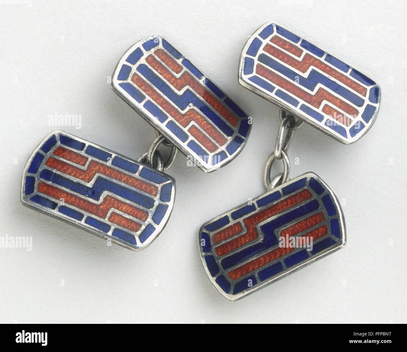 Pair of cufflinks in a blue and red geometric design Stock Photo