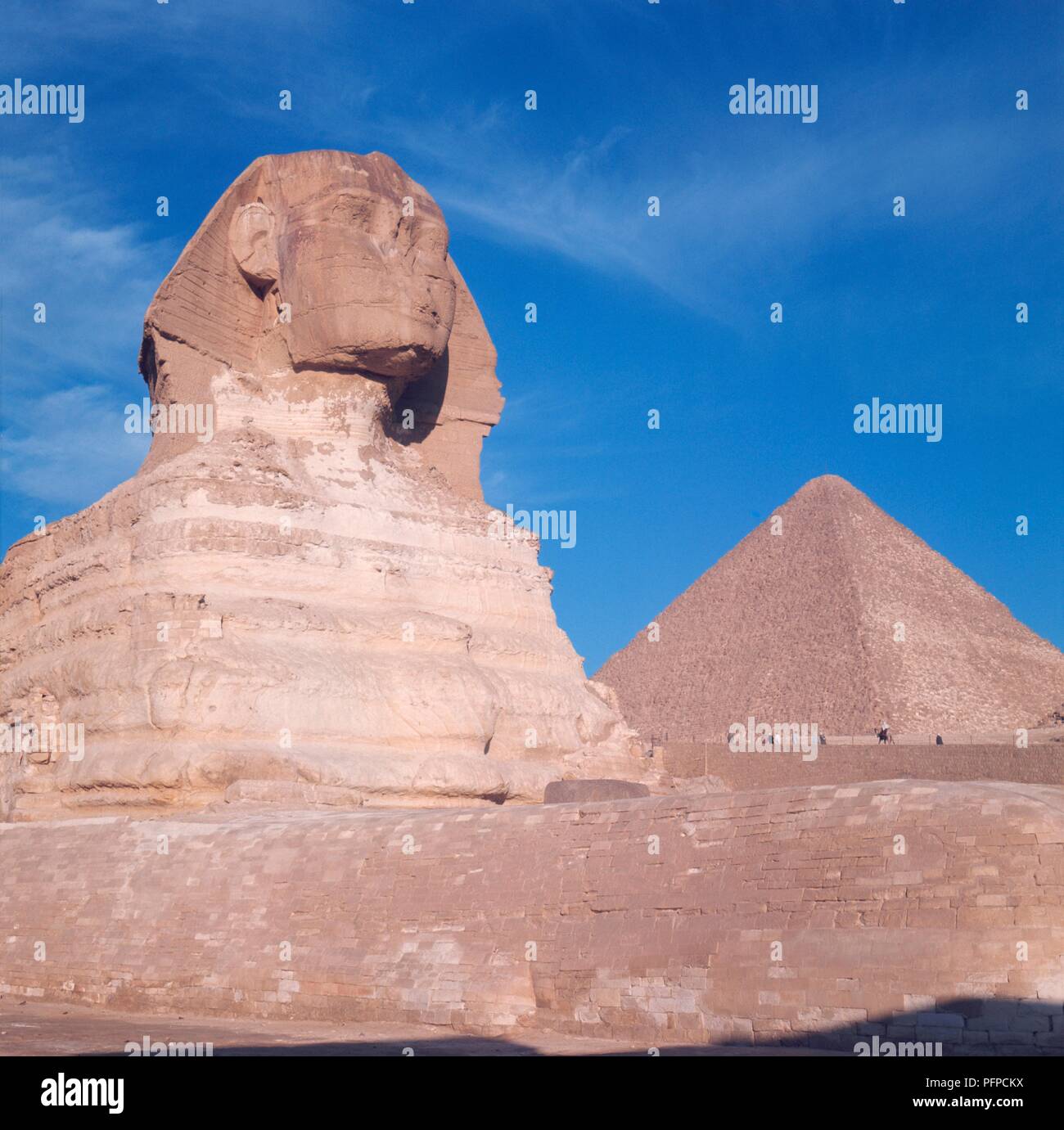 Egypt, Giza, The Sphinx against the Great Pyramid of Cheops Stock Photo ...