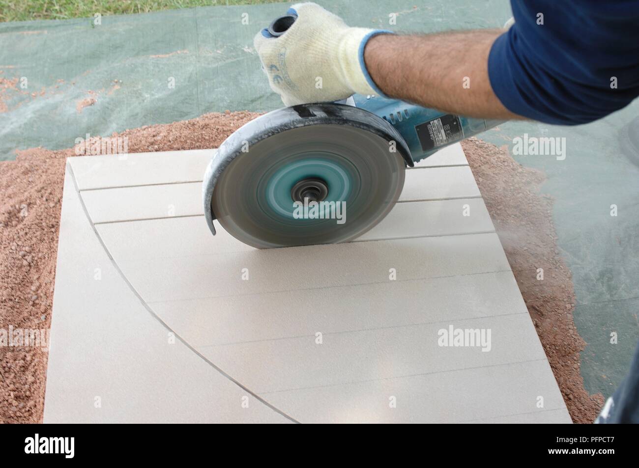 Man using angle grinder to cut slab, closeup Stock Photo Alamy