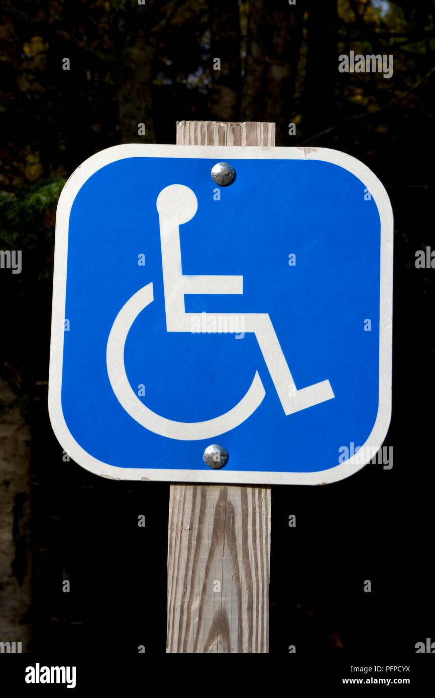 USA, New England, Wheelchair on disabled access parking sign on wooden