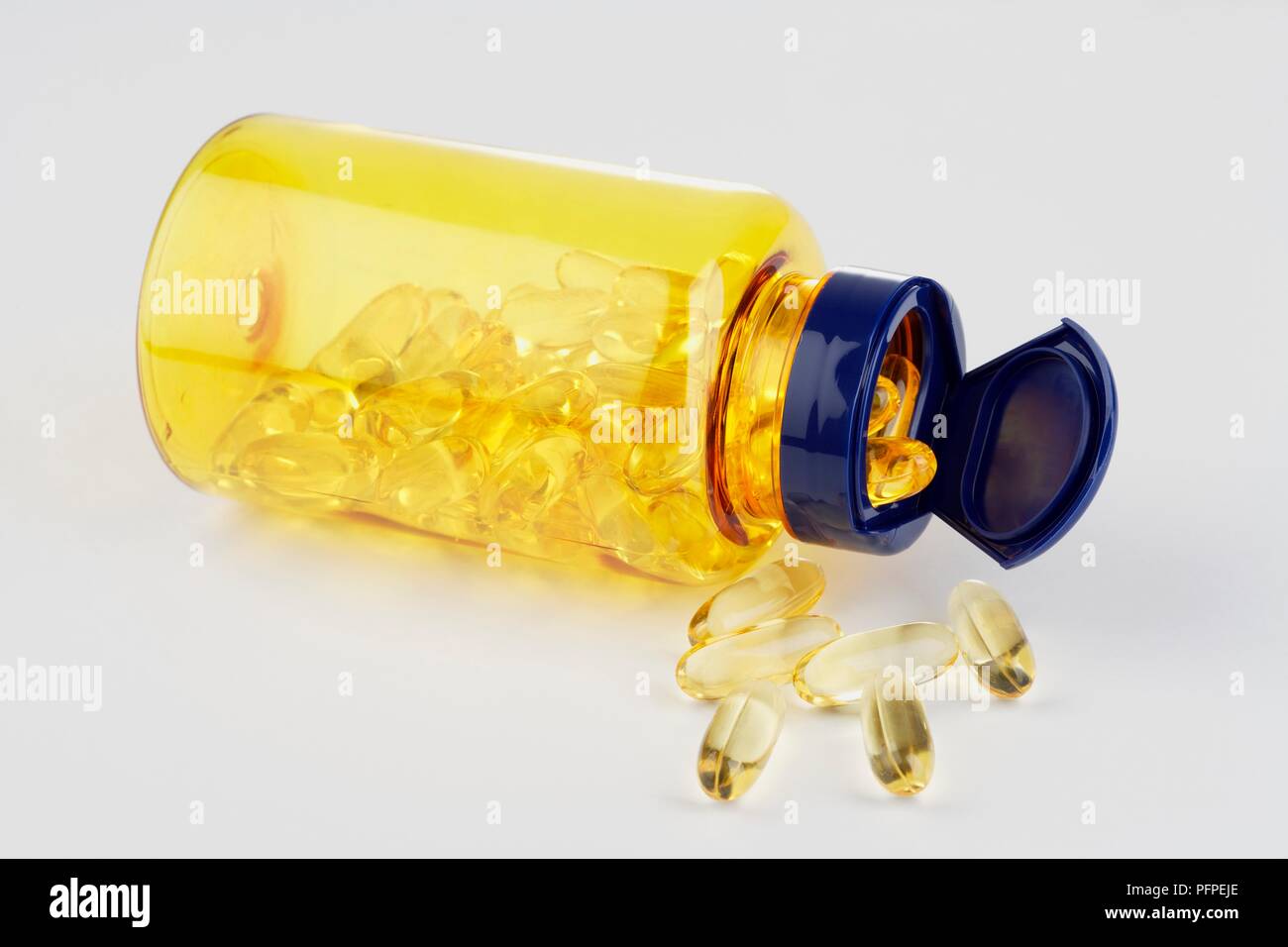 Download Cod Liver Oil Capsules Spilling From Yellow And Blue Pill Bottle Lying On Side Stock Photo Alamy PSD Mockup Templates