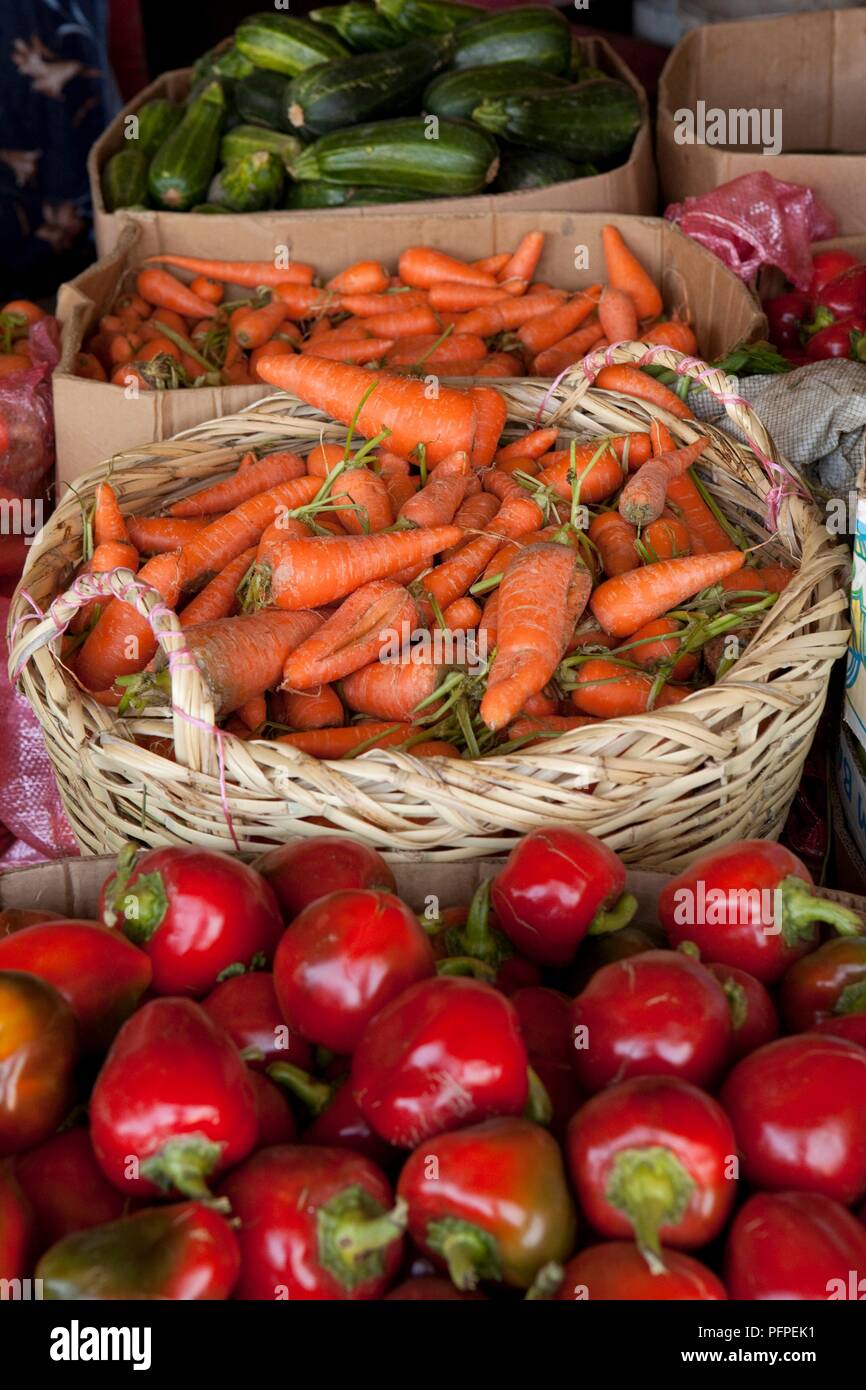 Chile, Coquimbo Region, Ovalle city, Feria Modelo market, basket carrots, marrow and red bell peppers in boxes on market stall Stock Photo