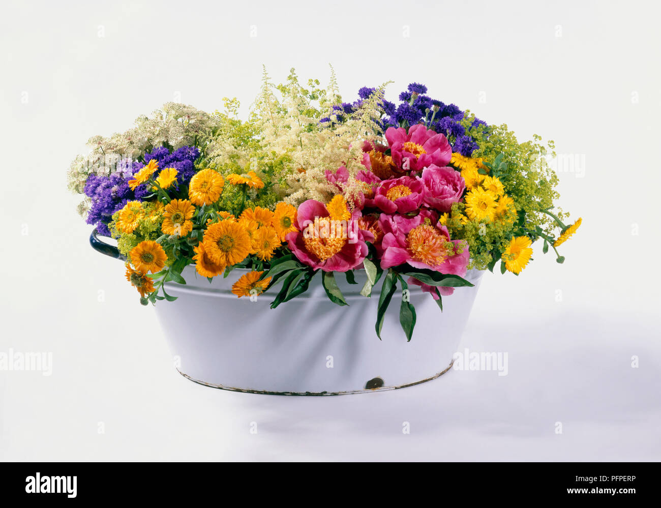 Summer flower arrangement in enamel tub Stock Photo