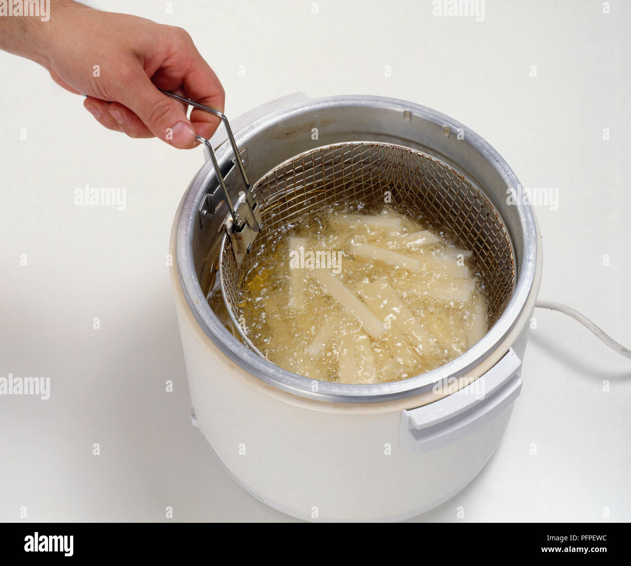 Cooking chips in pan Stock Photo Alamy