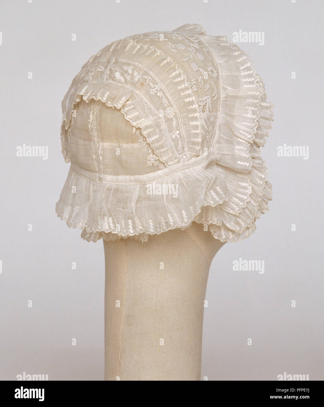 Embroidered silk bonnet on mannequin Stock Photo