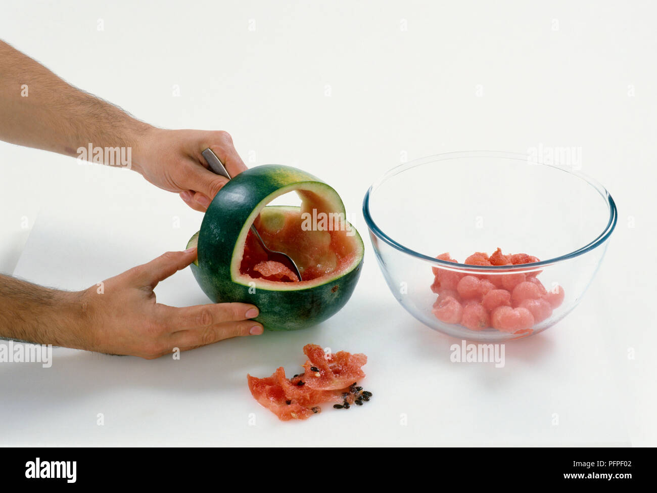 Scooping out watermelon using a spoon Stock Photo Alamy