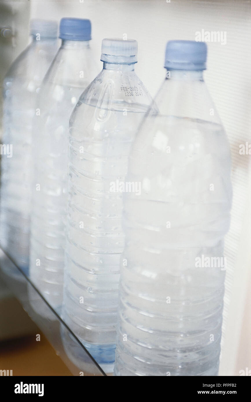 Plastic bottle contains cold water. Bottle covered with water