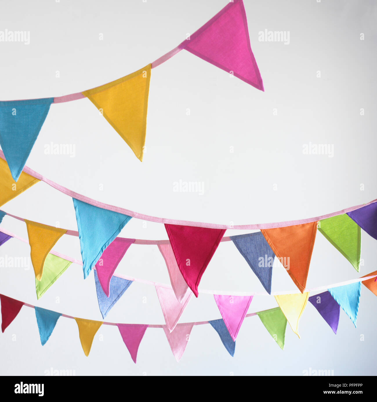 Triangular multi-coloured bunting hanging on lines Stock Photo