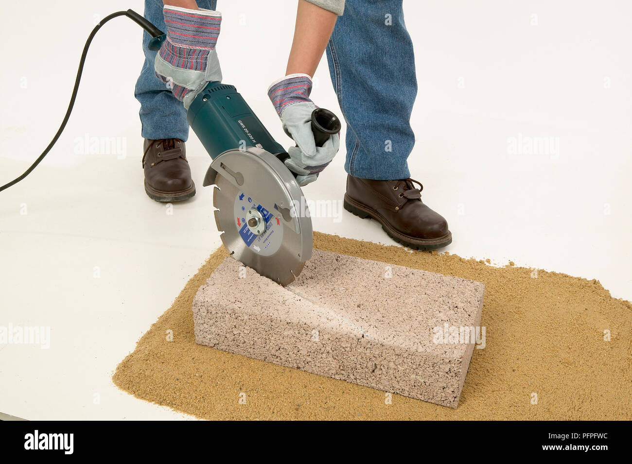 Using an angle grinder to cut a block diagonally Stock Photo - Alamy