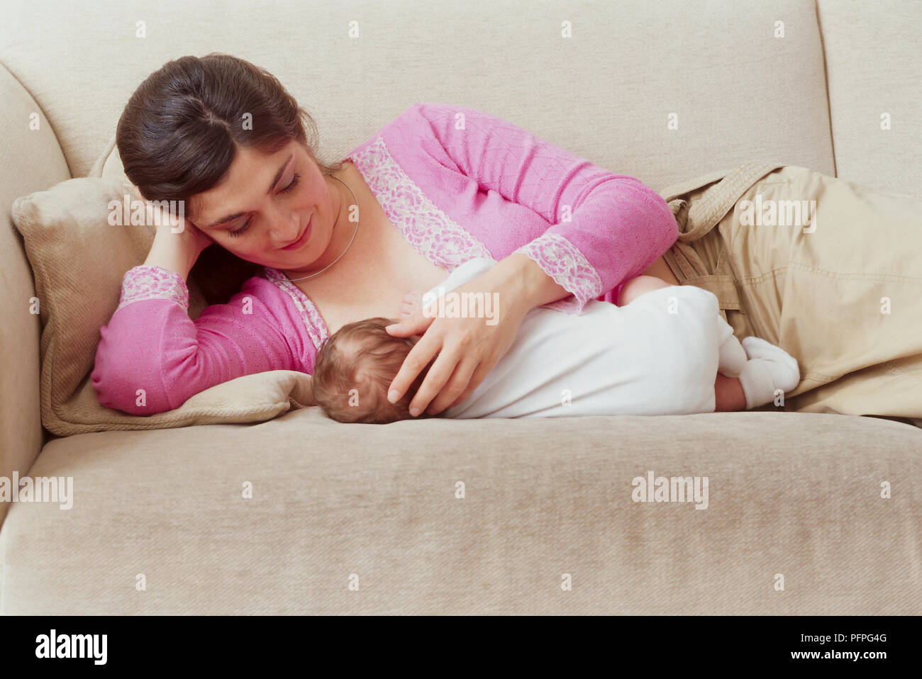 Woman breastfeeding close up baby boy hires stock photography and
