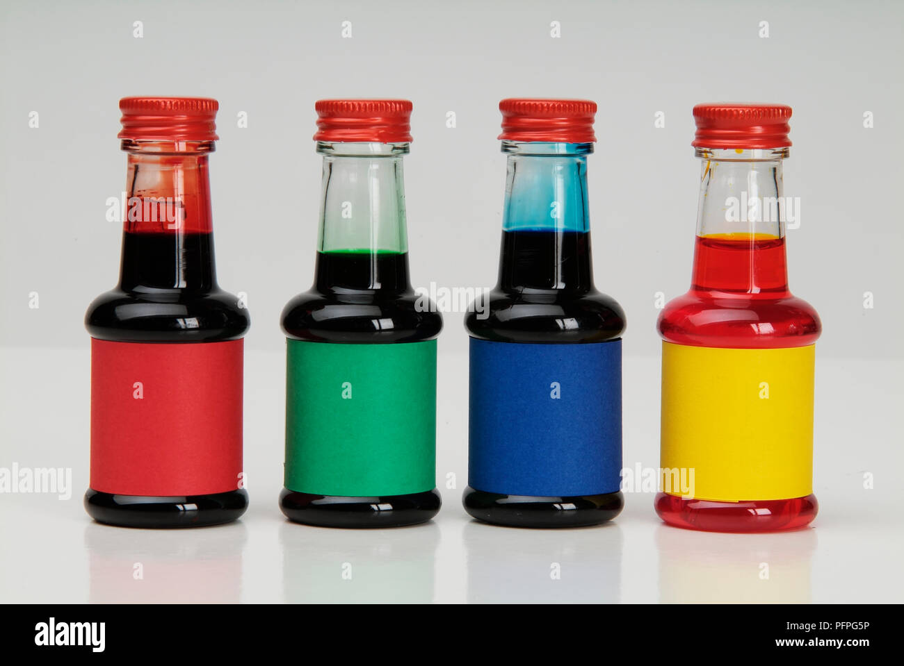 Four small bottles containing food colouring Stock Photo