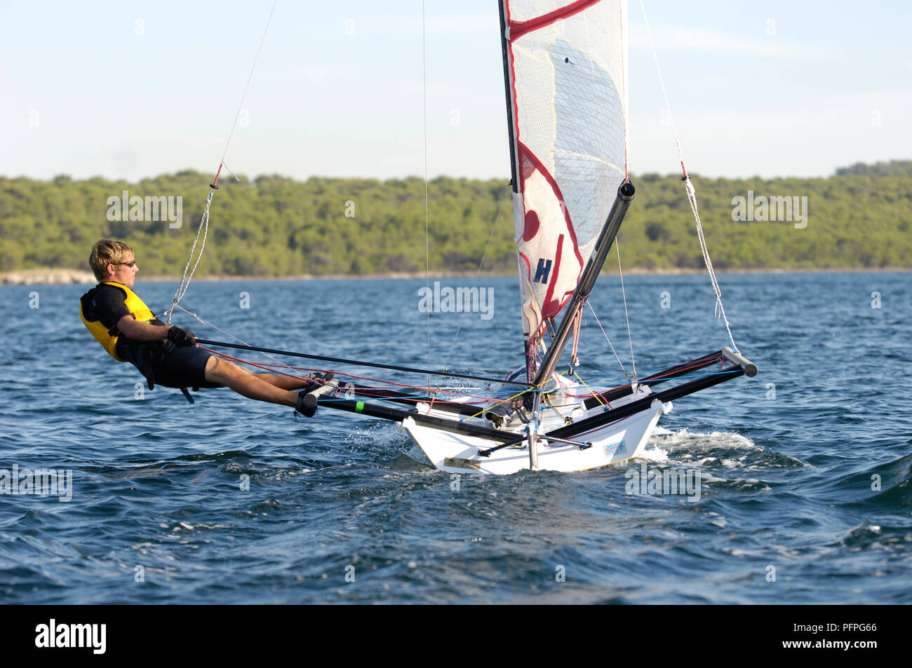 Spain, Minorca, young man sailing dinghy Stock Photo Alamy