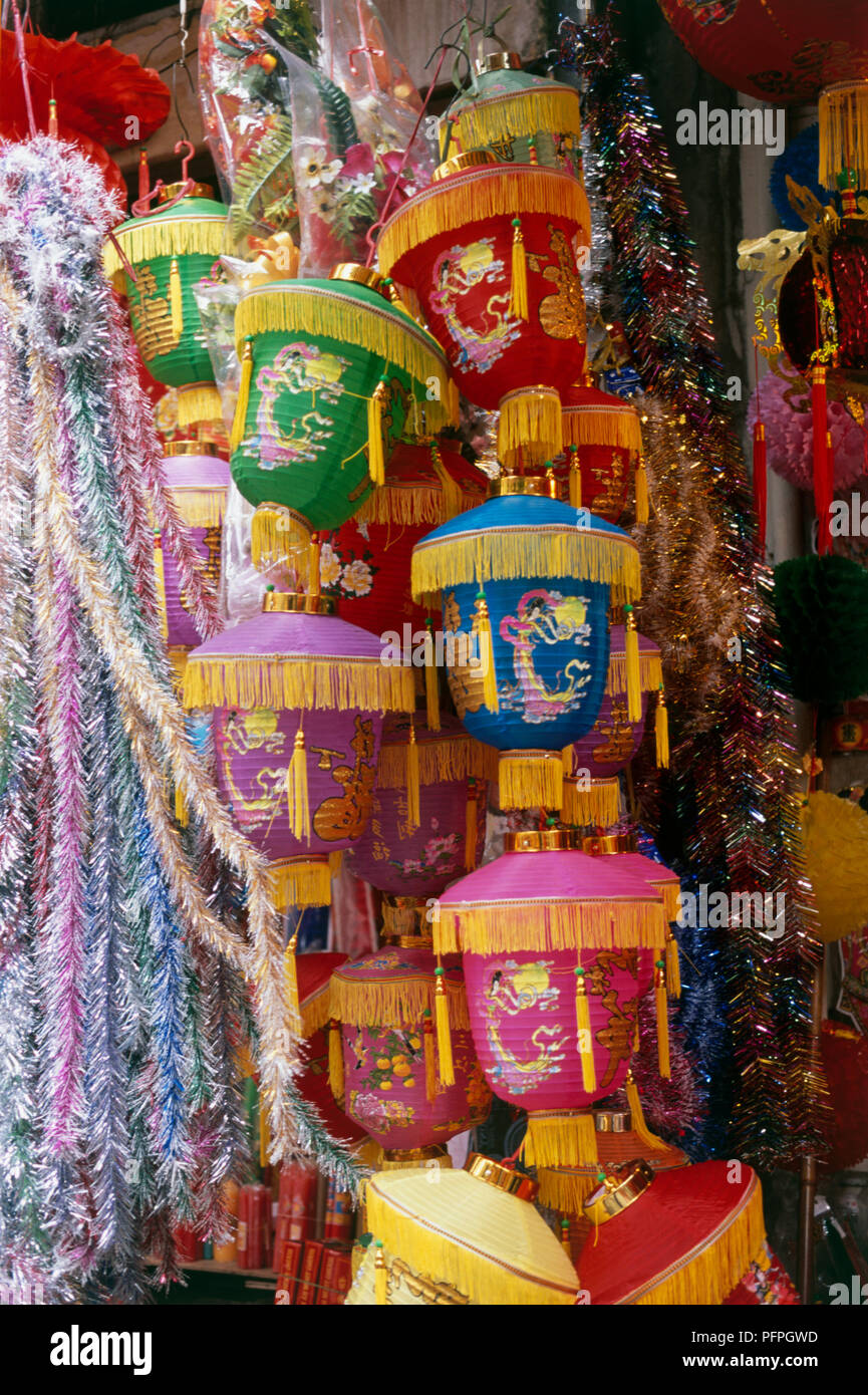 Paper lanterns and tinsel hanging outside shop on Hang Ma Street, Hanoi Stock Photo
