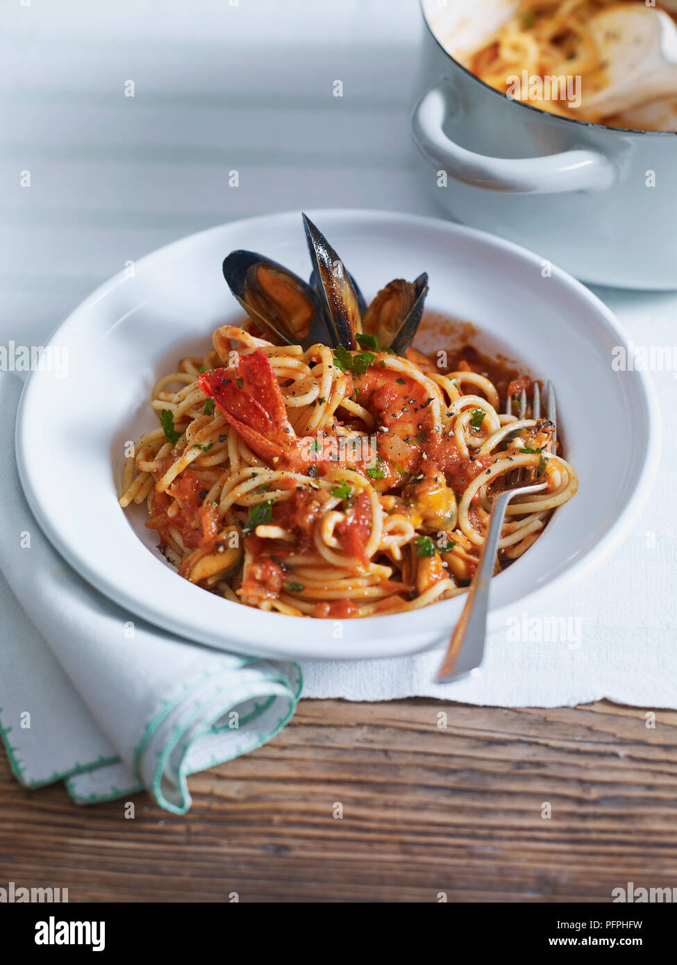 Spaghetti frutti di mare served in bowl with fork Stock Photo Alamy