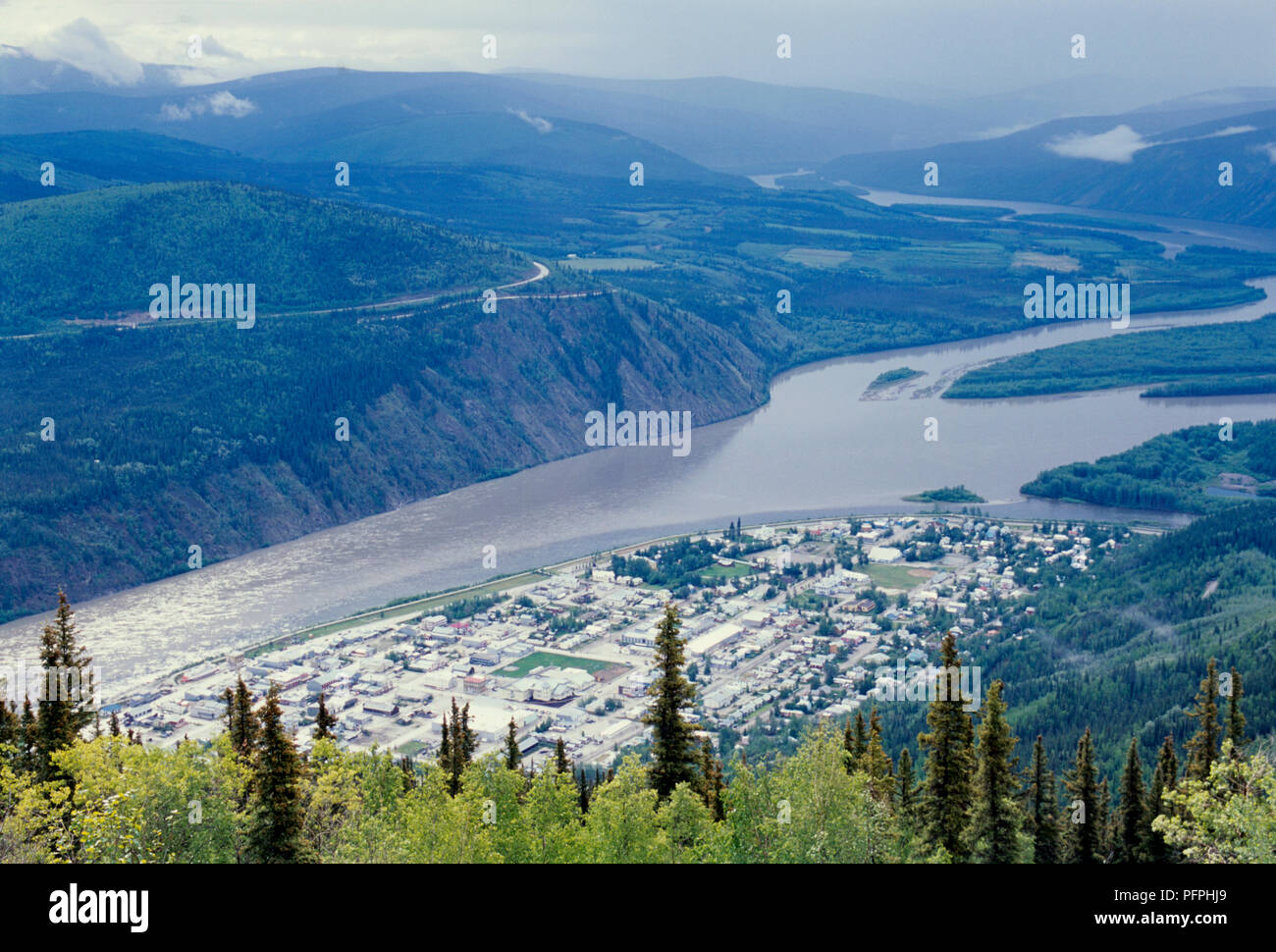 Canada, Dawson City, town on Yukon River seen from above on overcast day Stock Photo