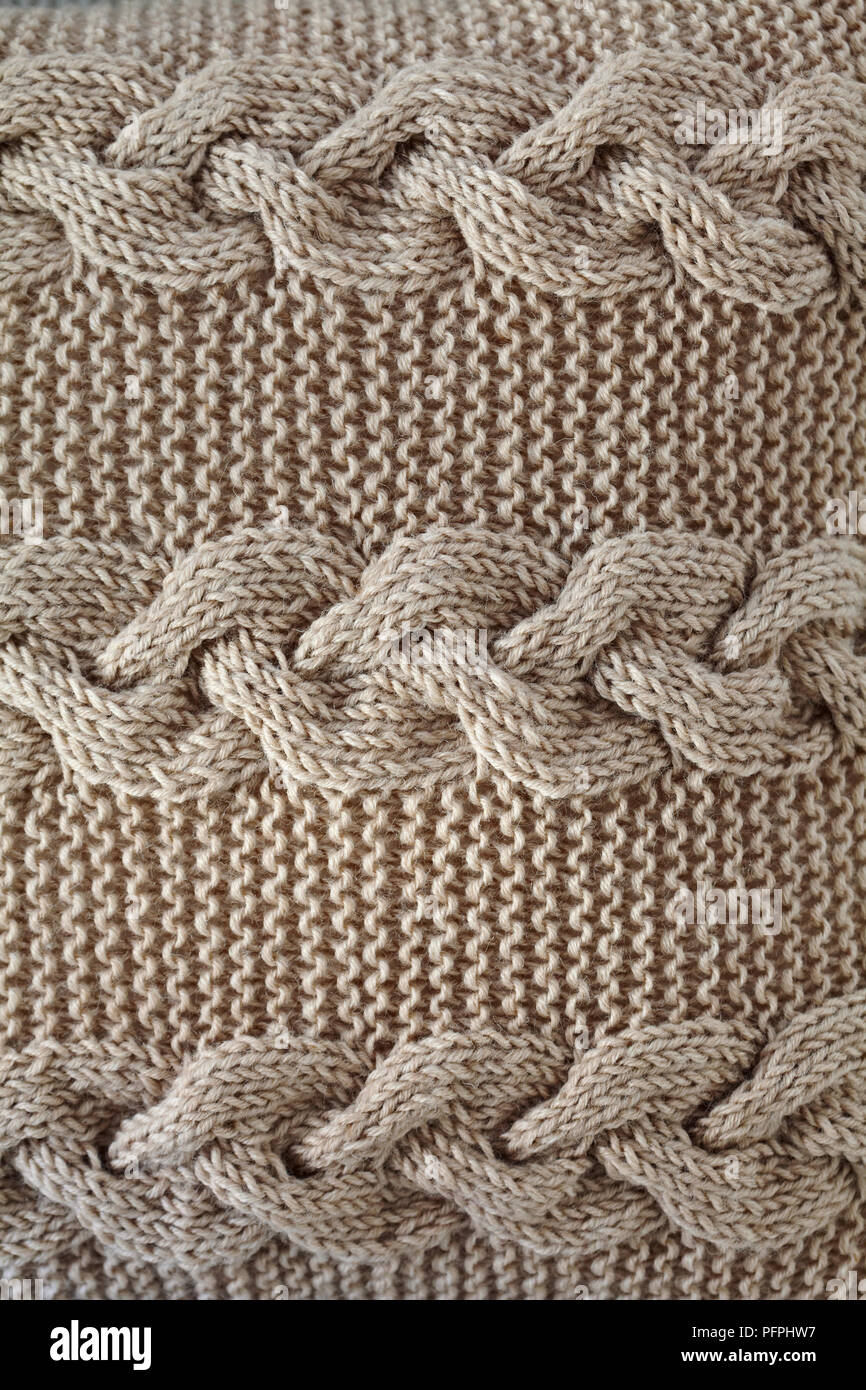 Cable stitch knitted cushion, close-up Stock Photo