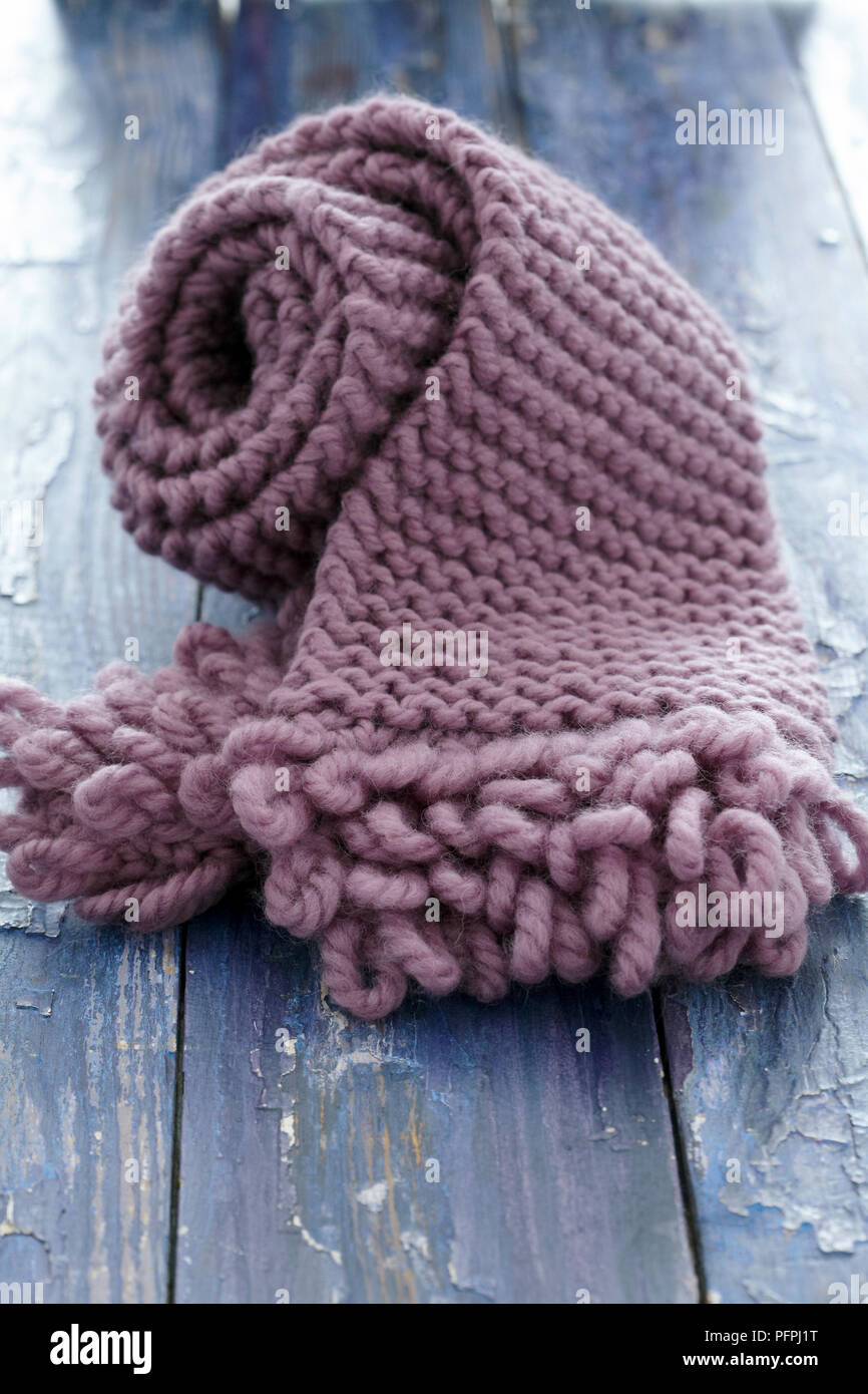 Pink knitted scarf with loop fringe on wood background Stock Photo Alamy