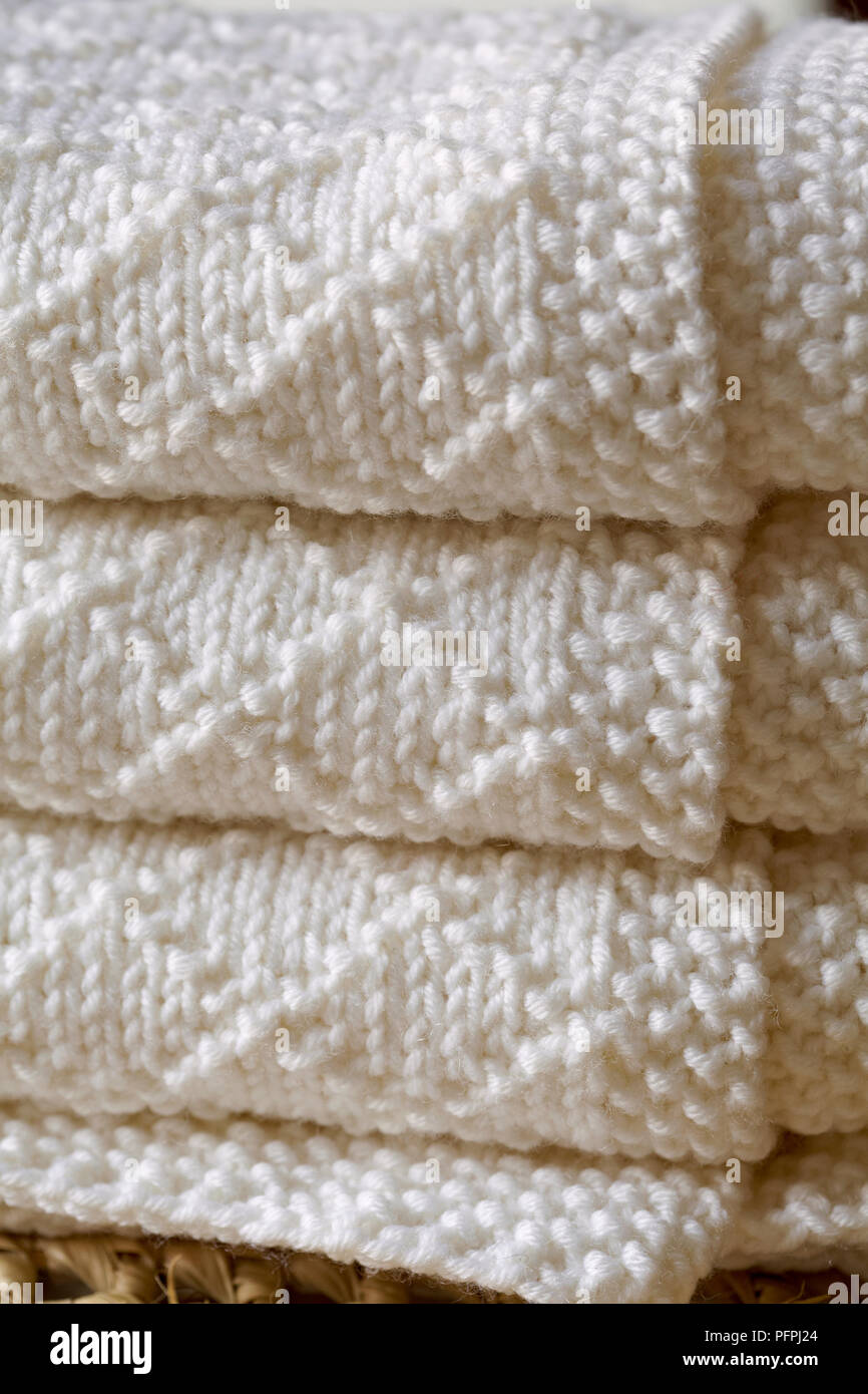 Baby's blanket knitted in natural wool yarn, close-up Stock Photo