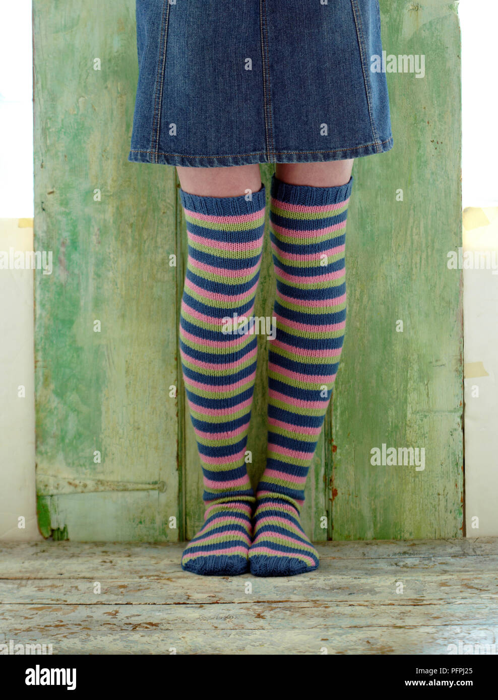 Girl wearing stripy knee-high socks Stock Photo