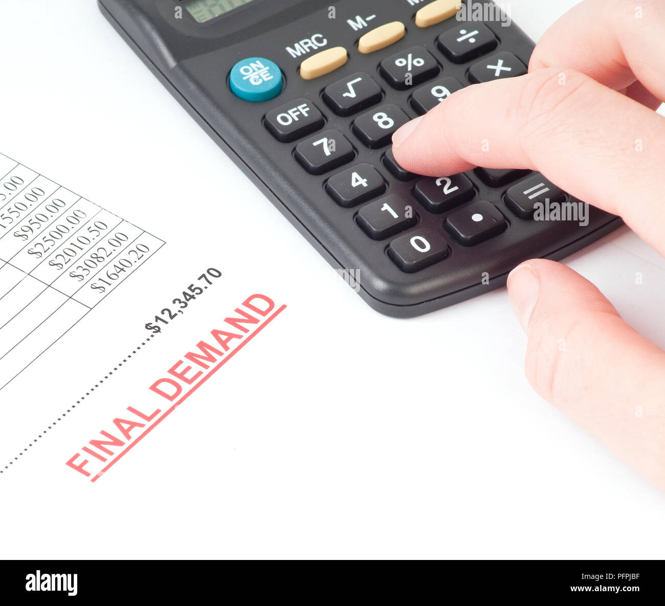 List of overdue payments with the words 'final demand' stamped on, and  person using a calculator Stock Photo - Alamy