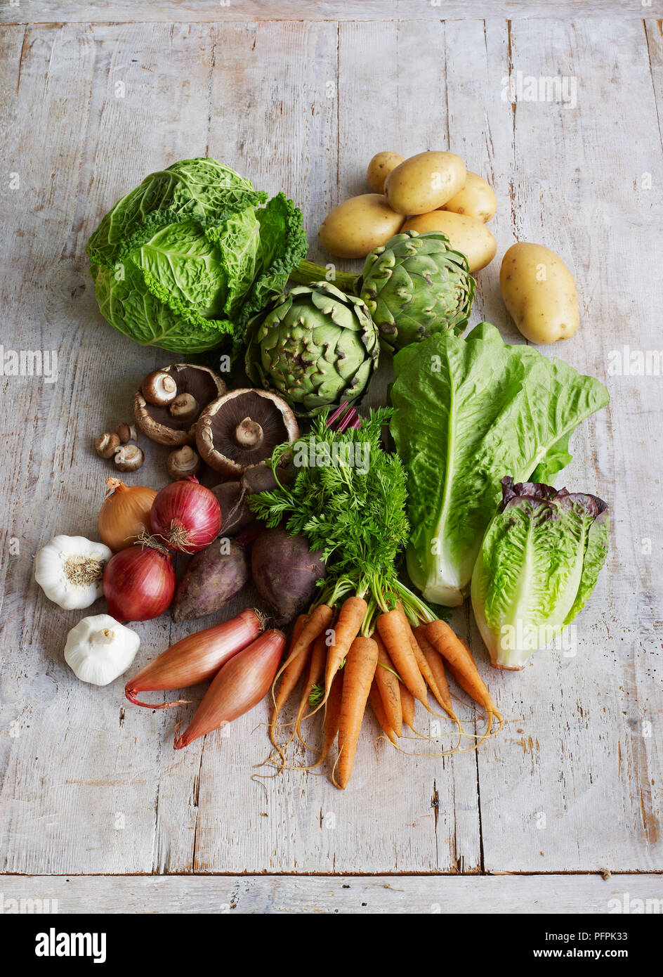 Various fresh vegetables and lettuce on wooden surface Stock Photo