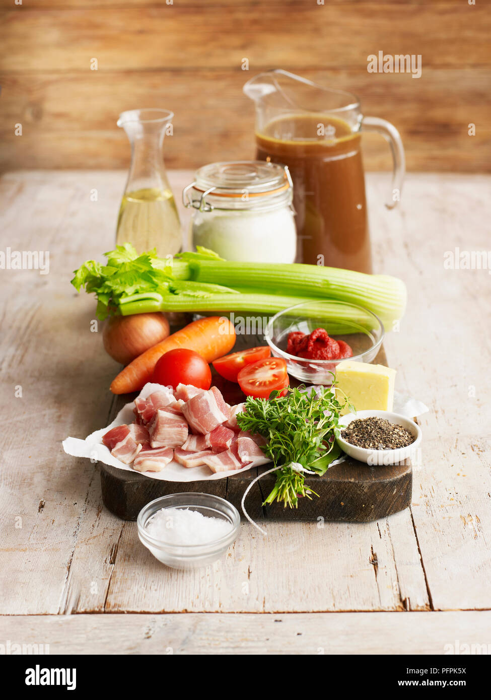 Ingredients for espagnole sauce, including jug of meat stock, vegetables, bouquet garni, pepper and salt, flour Stock Photo