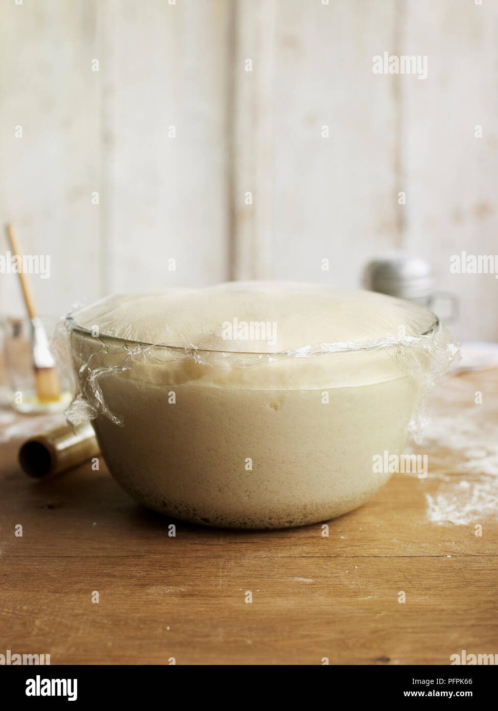 Bread dough rising in bowl, covered with clingfilm Stock Photo Alamy